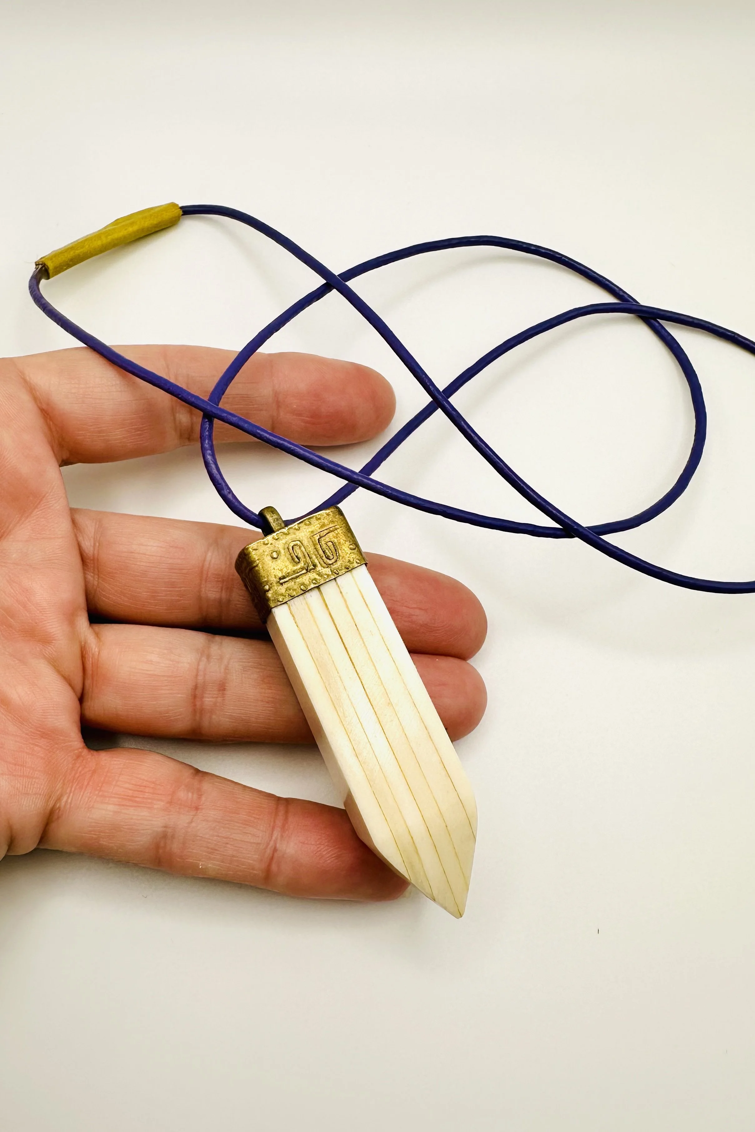 vintage bone point on purple leather