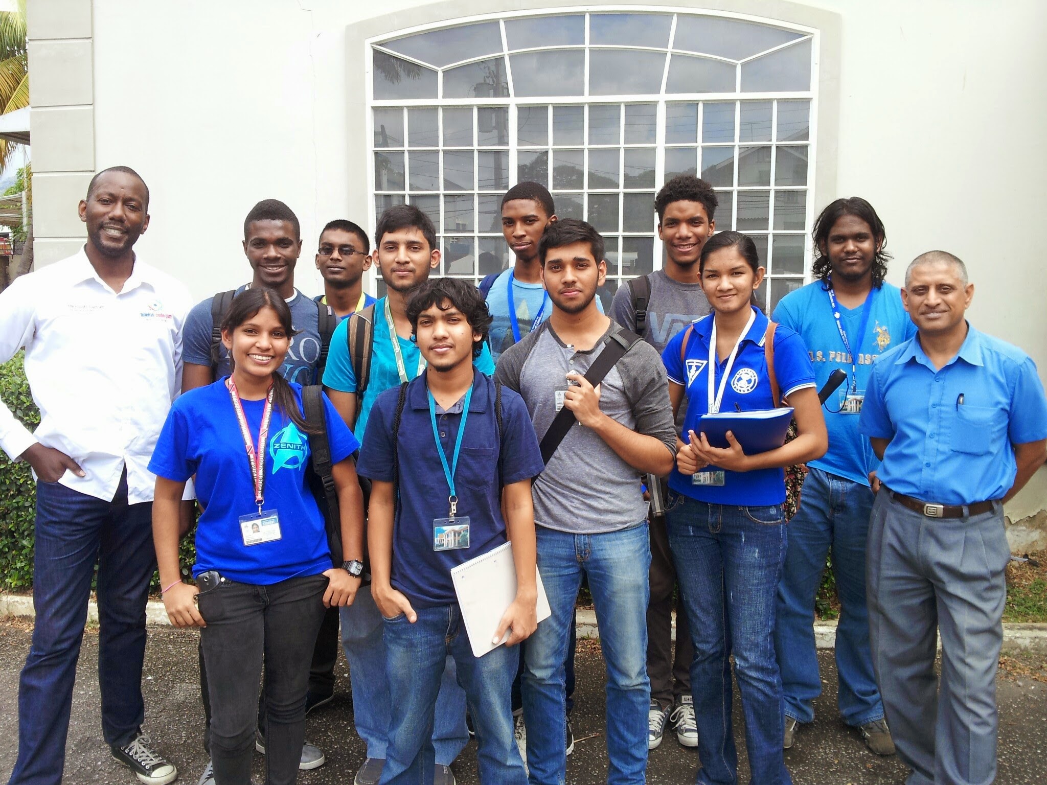 Irwin Williams –Teleios (left) stands next to University of the West Indies St. Augustine Campus’ faculty of Electrical and Computer Engineering year one students and lecturer Dr. Musti Sastry.