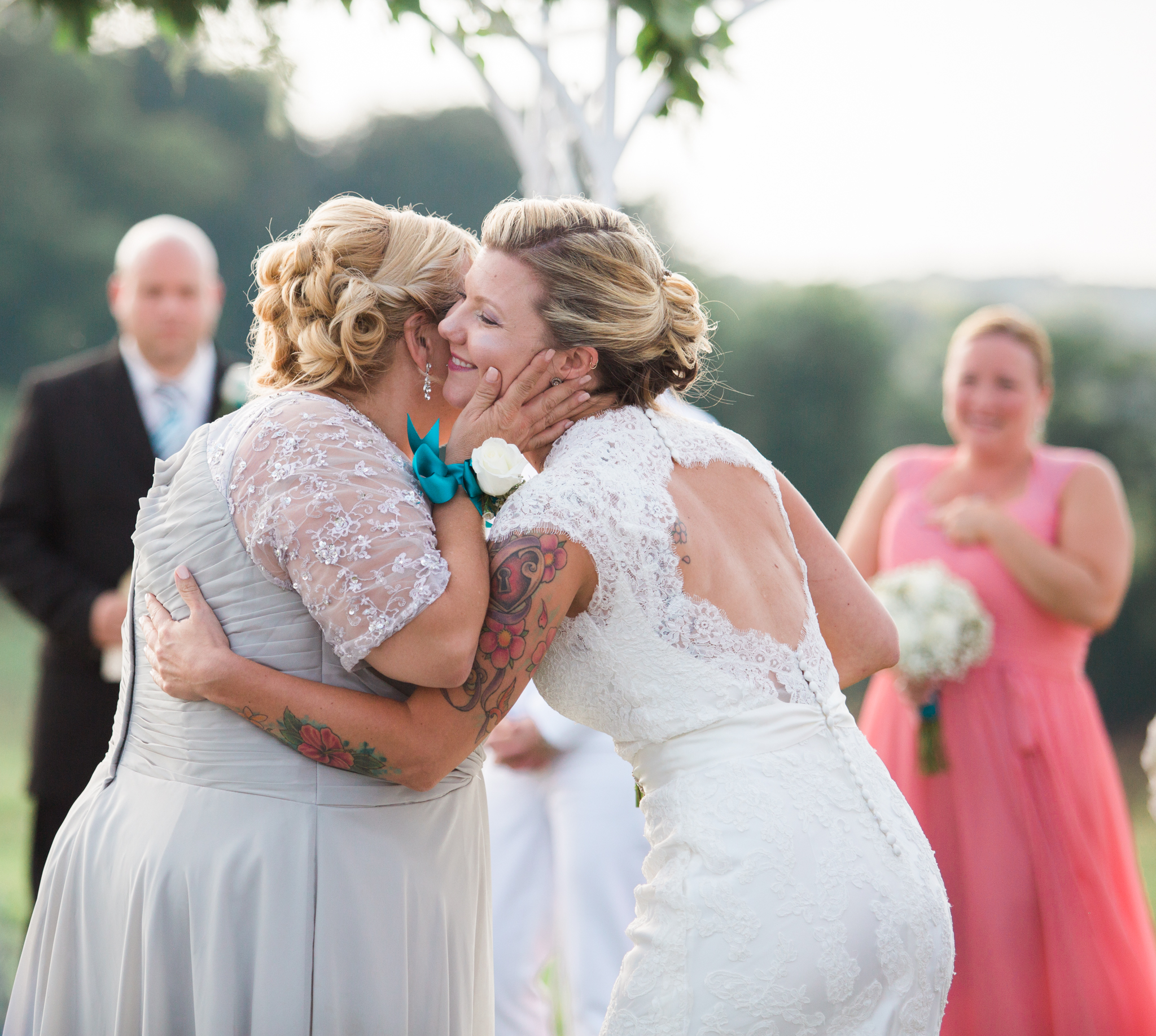 Photo of bride kissing mom on cheek at wedding at Linganore Winecellars in Maryland