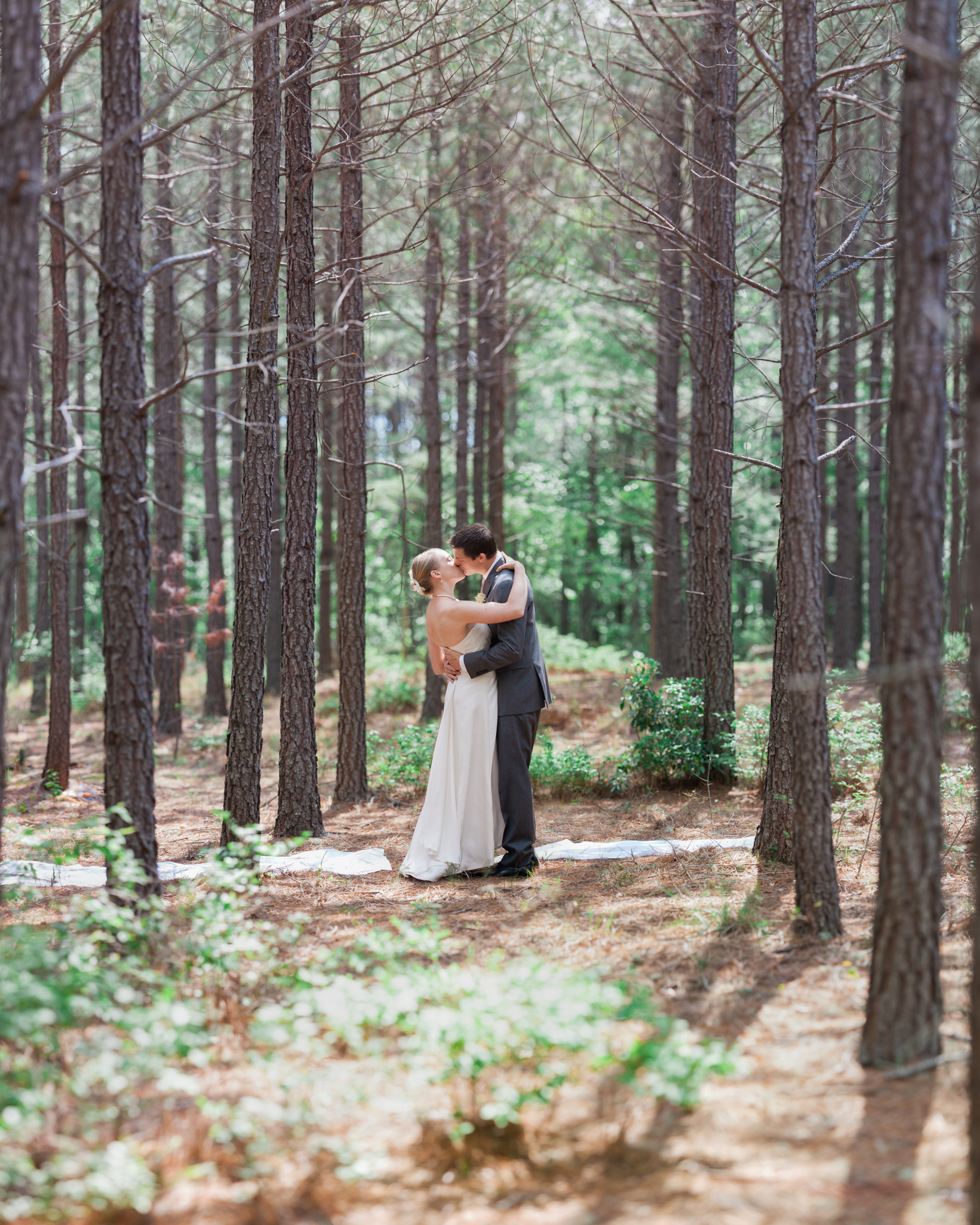 Bride and groom kissing in trees in King George Virginia