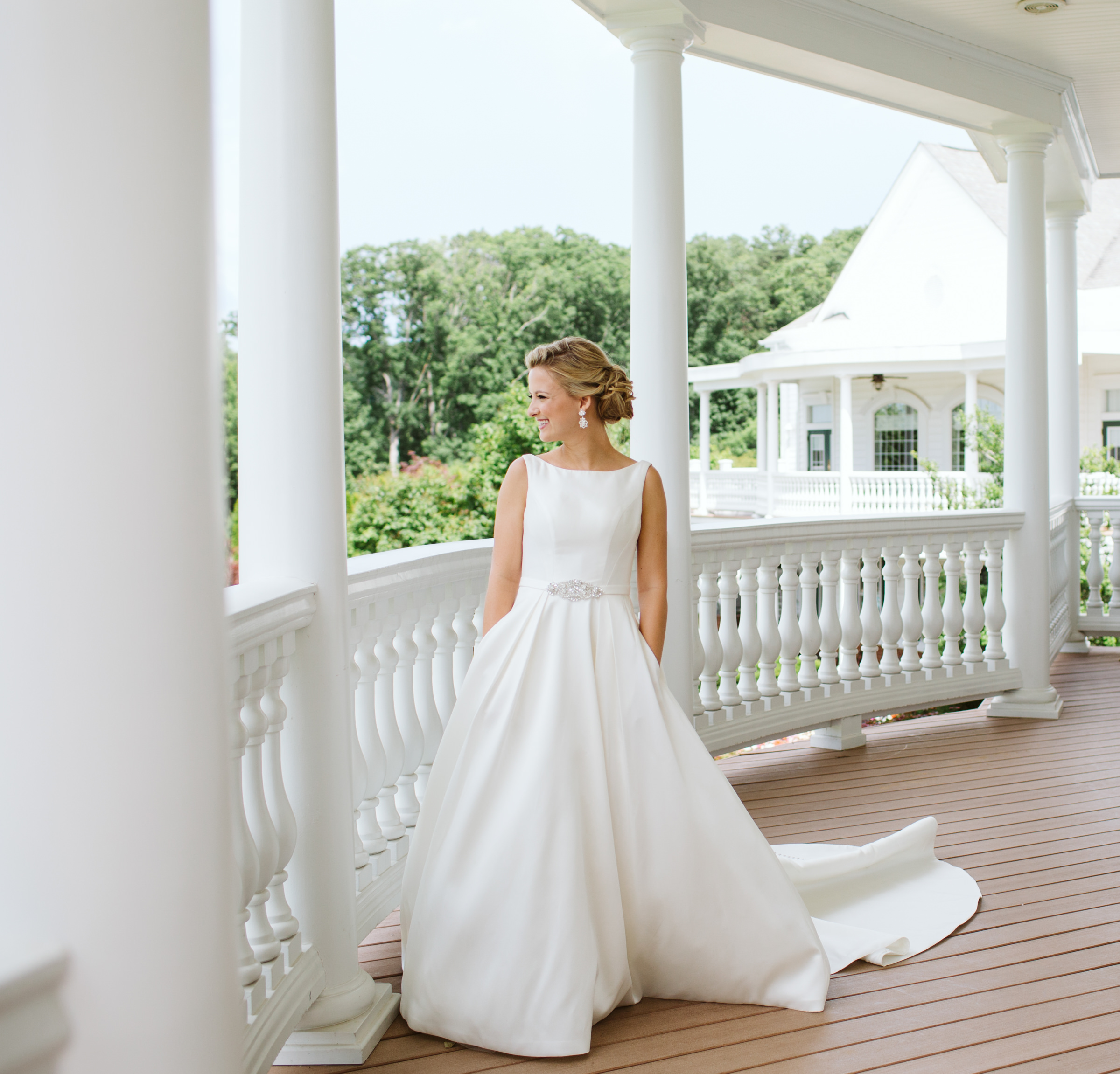 Bride standing on porch at Heritage Hunt Country Club in Gainesville Virginia