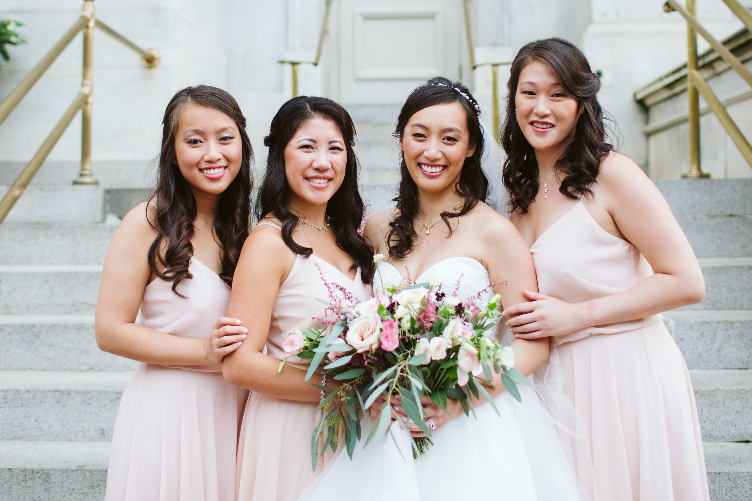 Bridesmaids standing on marble steps at Hotel Monaco DC Washington