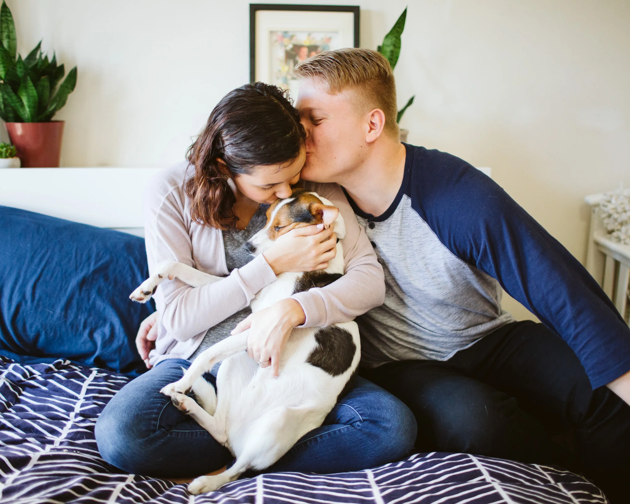 Couple with dog on bed lifestyle family photography session