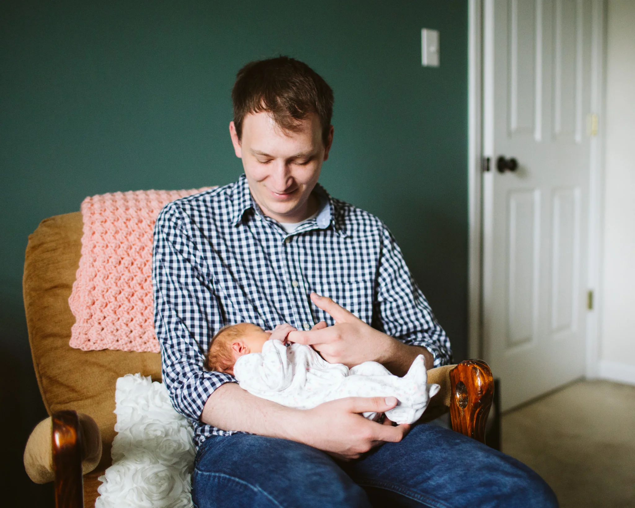 Dad holding baby during family lifestyle photography session