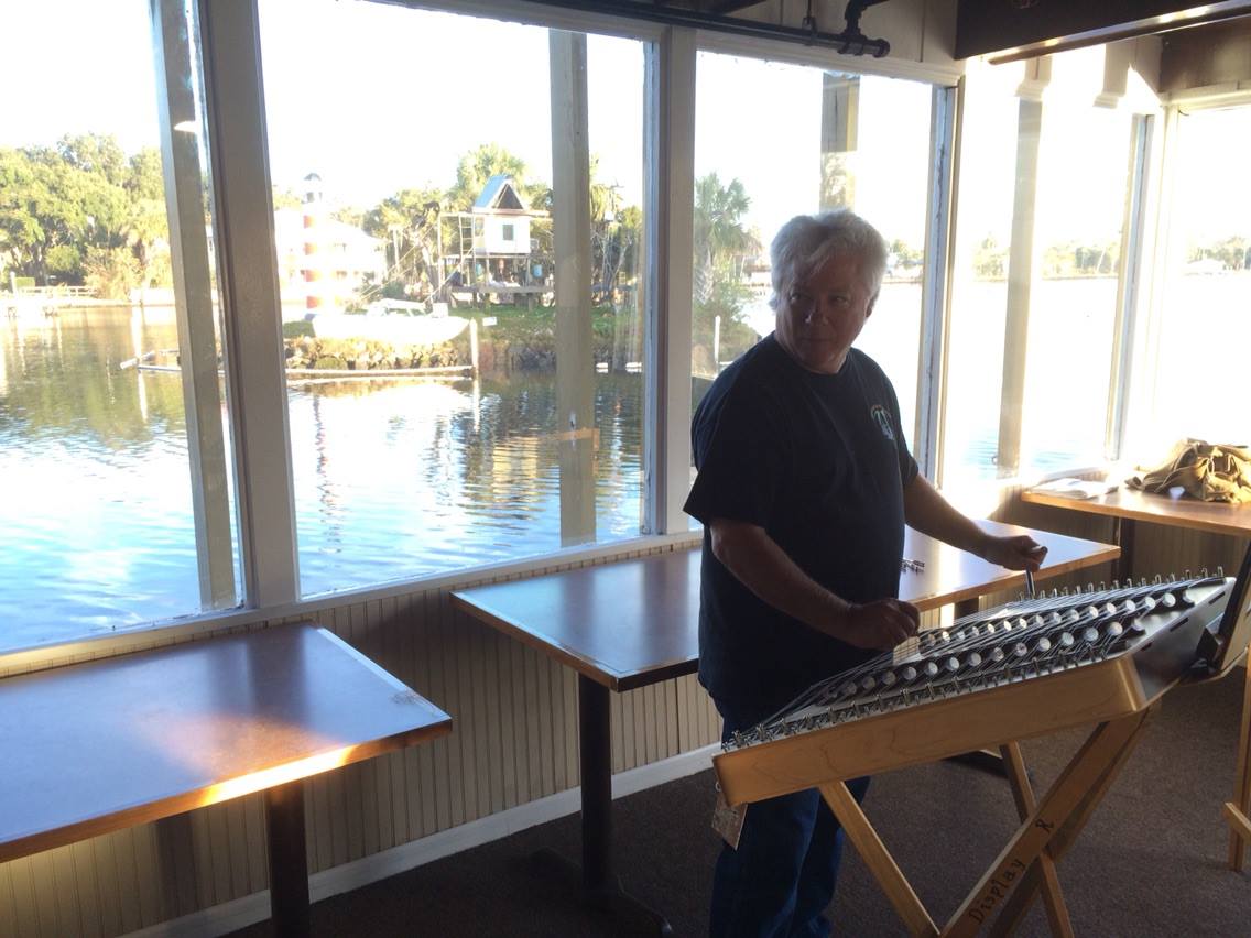Guy George prepares to teach a hammered dulcimer workshop with Monkey Island in the background.