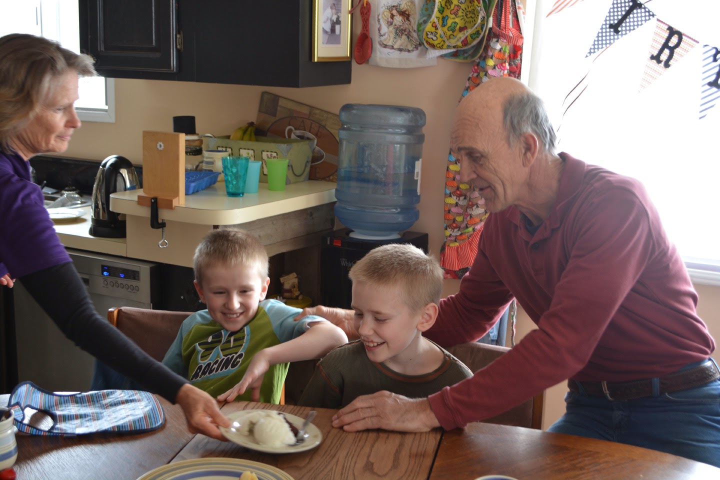 Grandpa Mike can't help but tease the boys. Grandma Laurel helps me serve dessert.