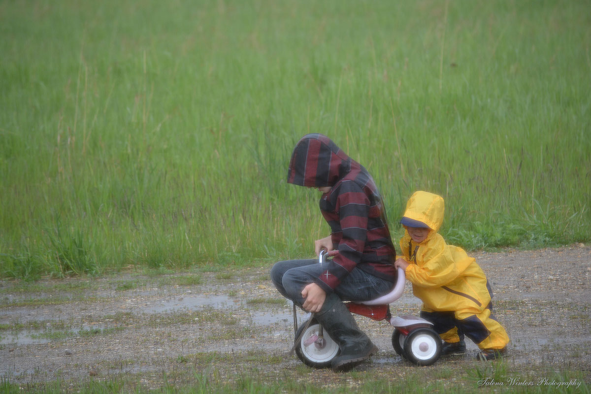 Last June, pushing Jude on his own tricycle. Yes, Levi's idea!