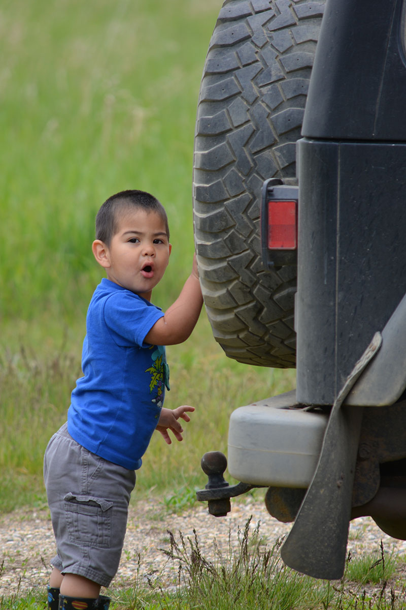 Last summer, checking out the spare on Papa Stanley's Jeep.