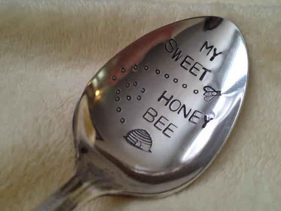 Stir in your honey with a hand stamped spoon from BellaJacksonStudios on Etsy .