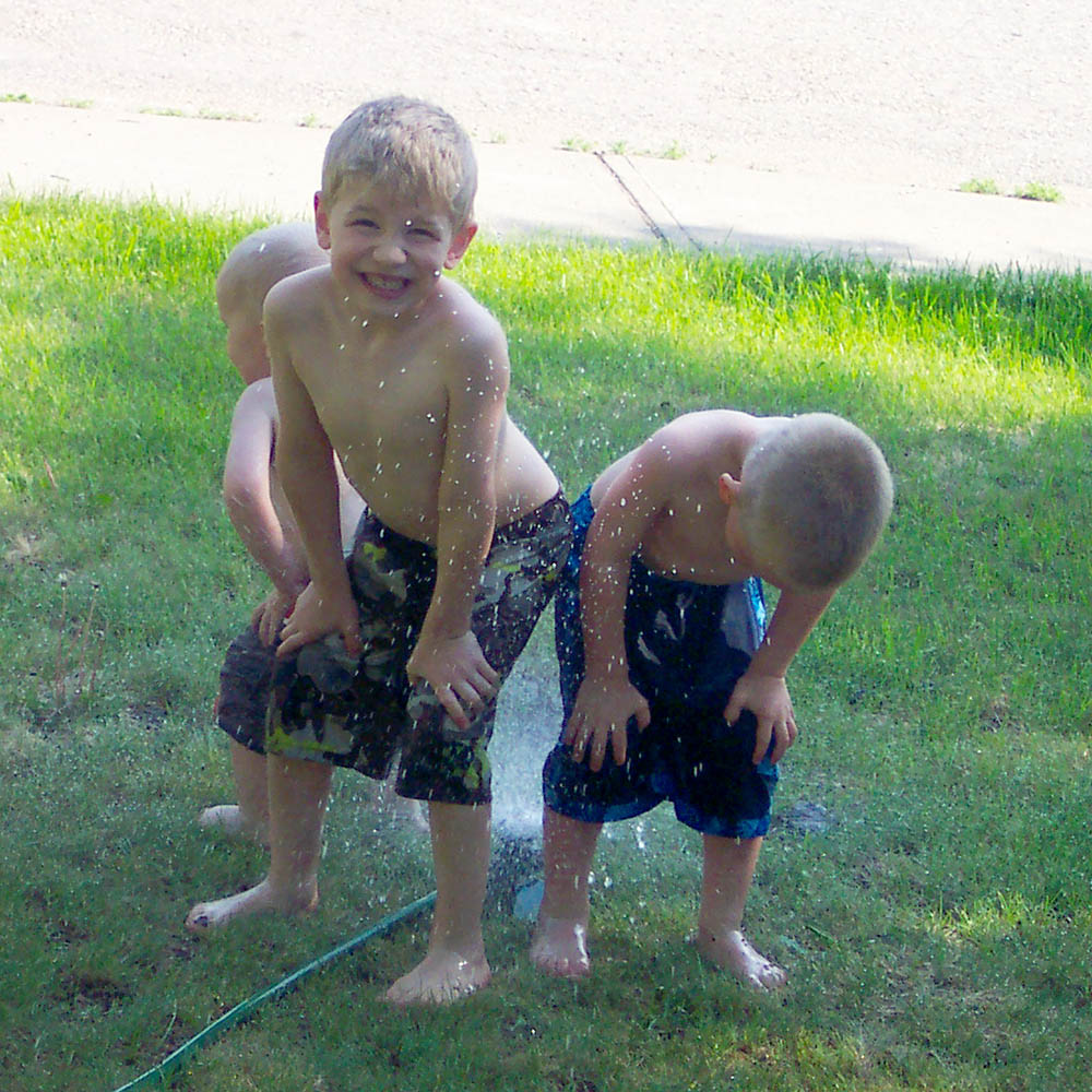 I found this photo of Jude, Noah, and Jabin enjoying the sprinkler in our front yard in the archives last night. Photo taken June 2, 2008.