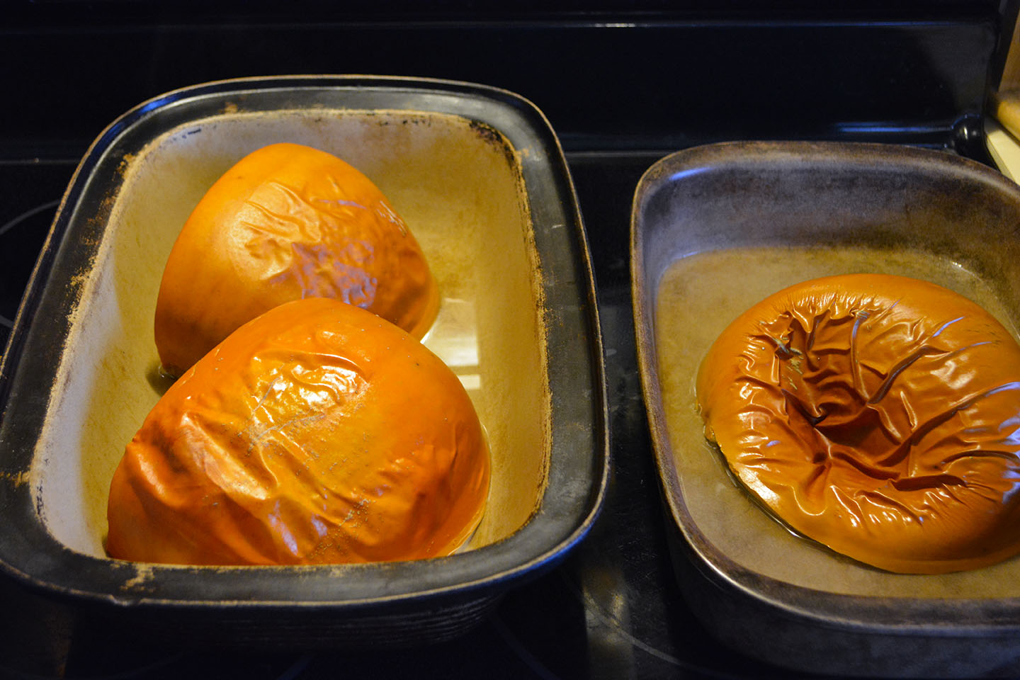 Pumpkin after it has been cooked. The skin has blistered somewhat and the most cooked one has deflated.
