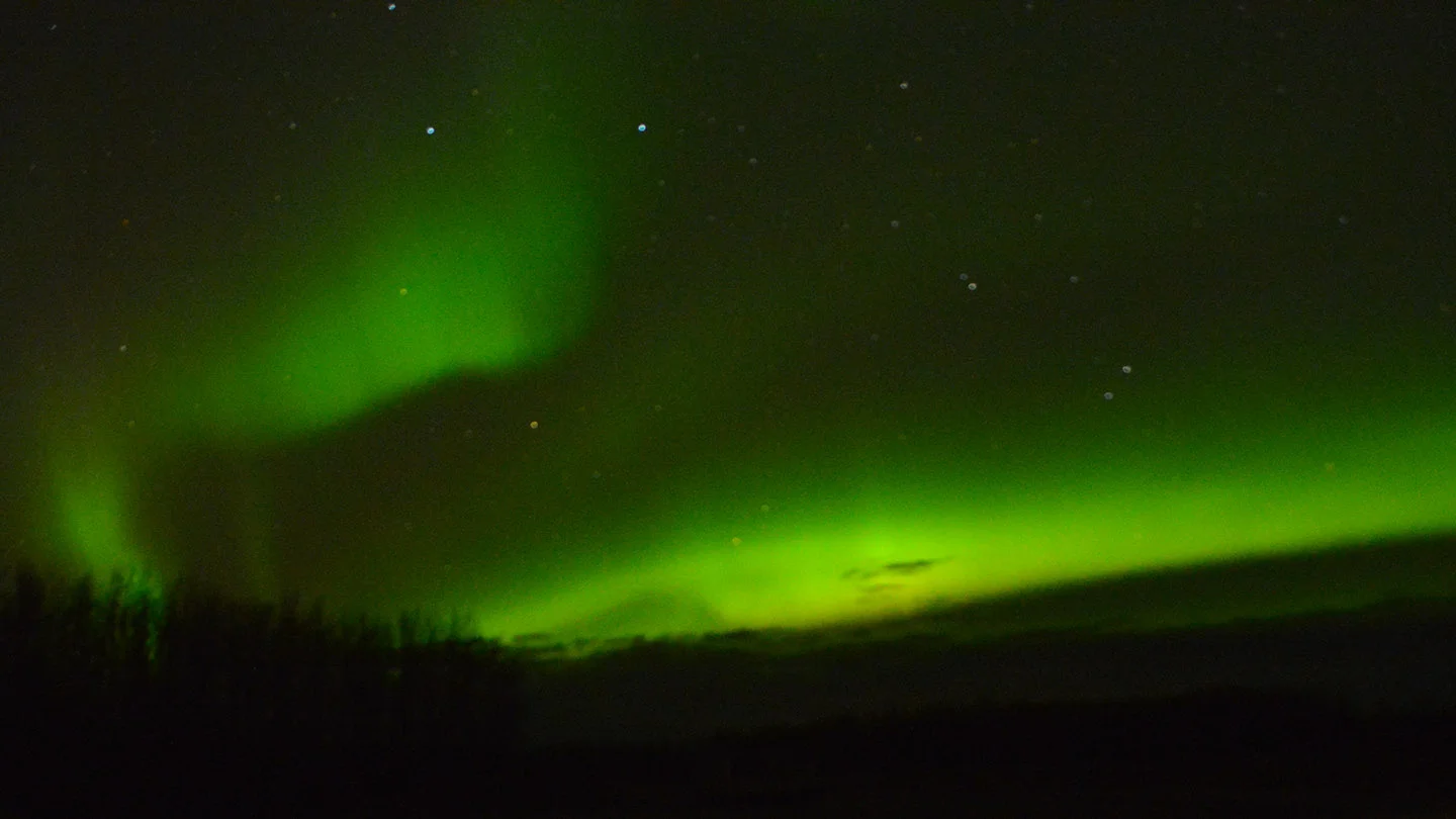 A stunning display of Northern Lights on an only mildly-chilly evening with a camera handy and some time to experiment resulted in this photo. It was pretty fun.