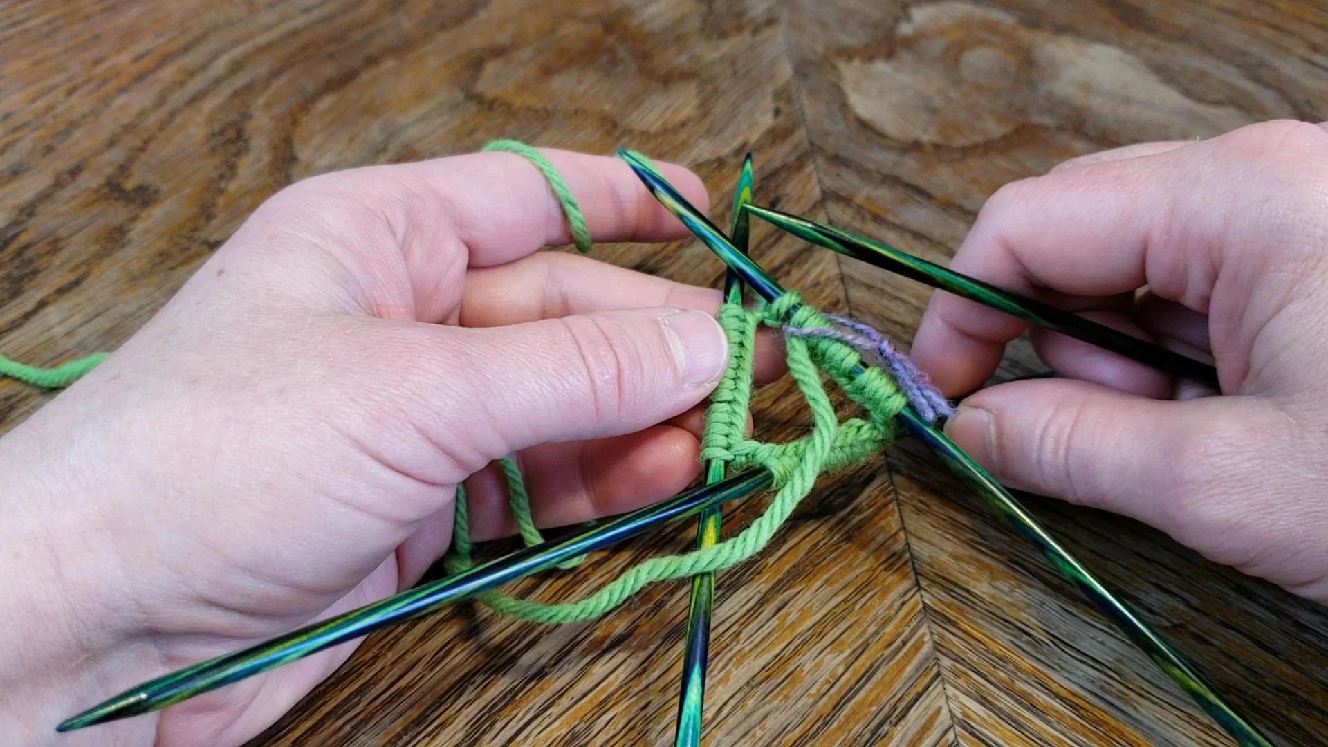 Joining yarn in the round is as simple as working the first stitch of your first round. Just make sure you keep everything straight. Twister is a party game, and doesn’t work on your needles.