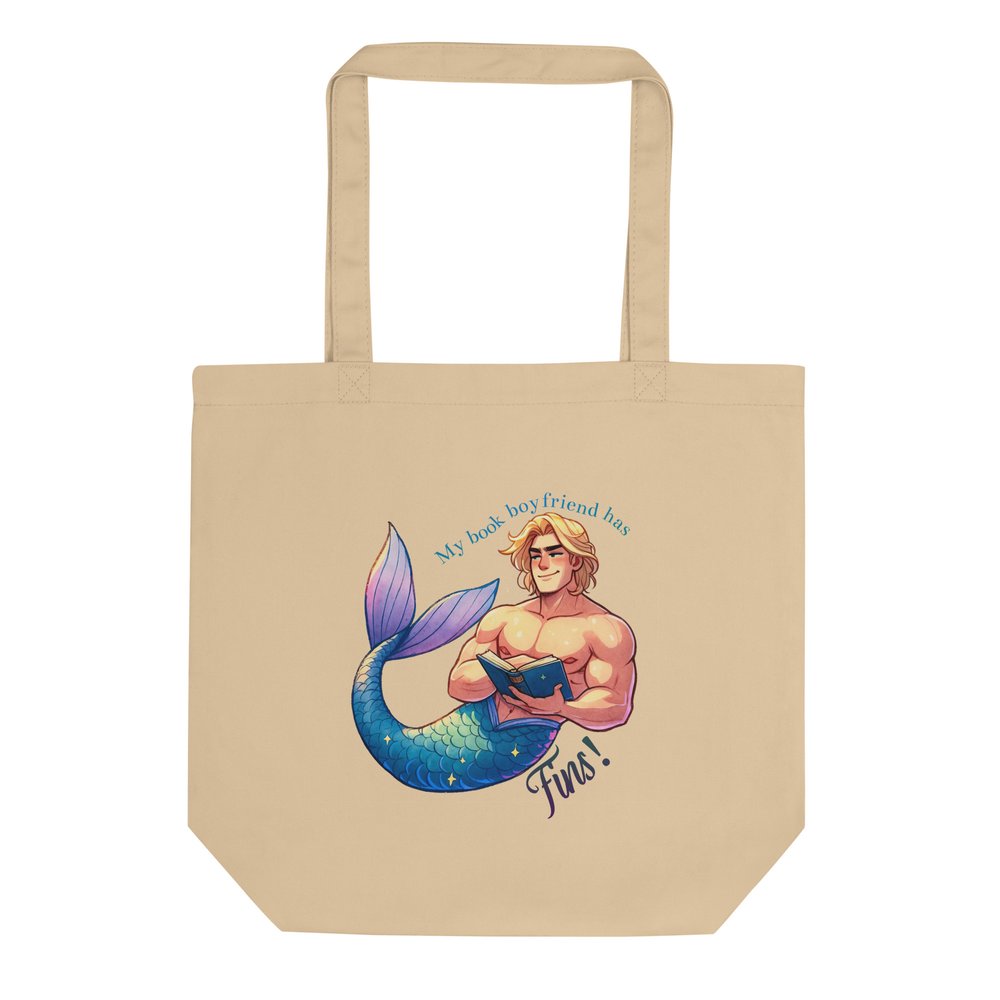 Light tan medium cotton tote bag with merman illustration graphic and text "My book boyfriend has fins!"