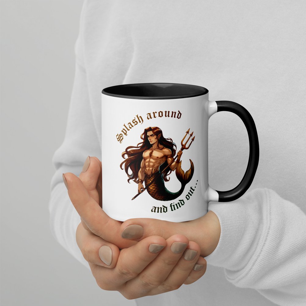 11-ounce white ceramic mug with black handle and interior showing a colourful illustrated graphic shows a hunky devilish-looking merman holding a trident with the text "Splash around and find out...”