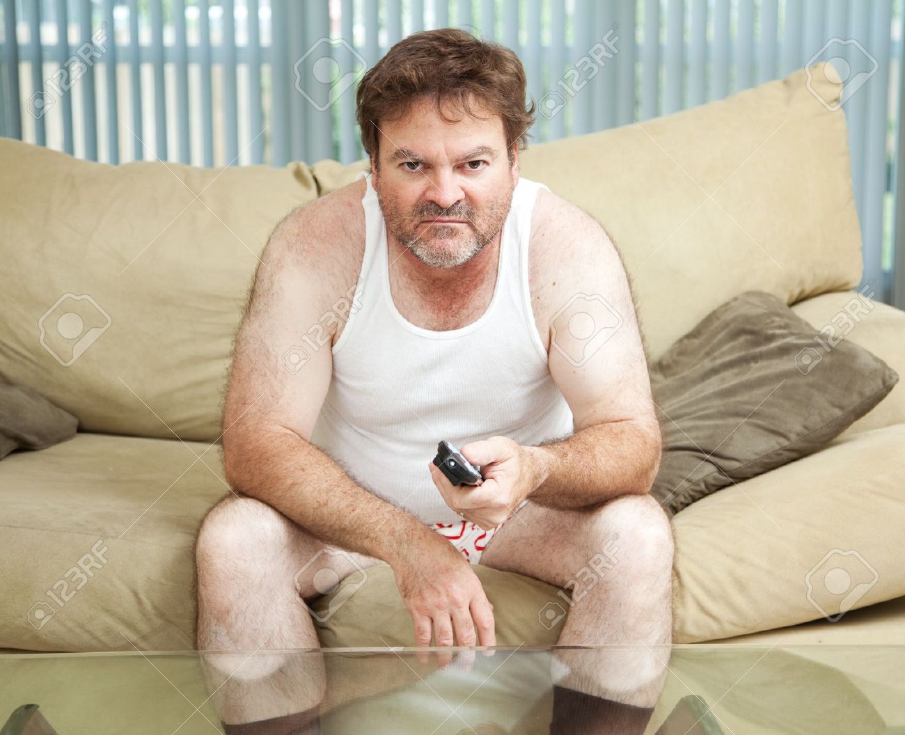 21788302-Unemployed-man-sitting-home-watching-TV-bored-and-discouraged--Stock-Photo.jpg