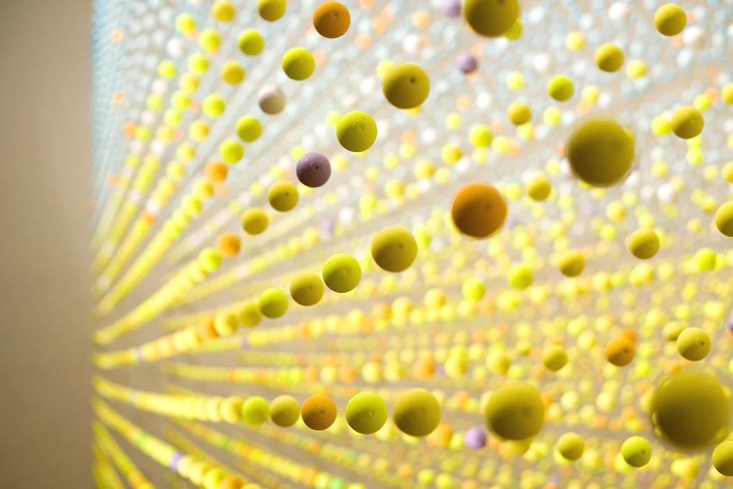 Atomic: In Full Sunlight , 2008, Polystyrene balls, paint, nylon wire, electric fans, nstallation view (detail)