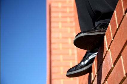 man-standing-on-ledge