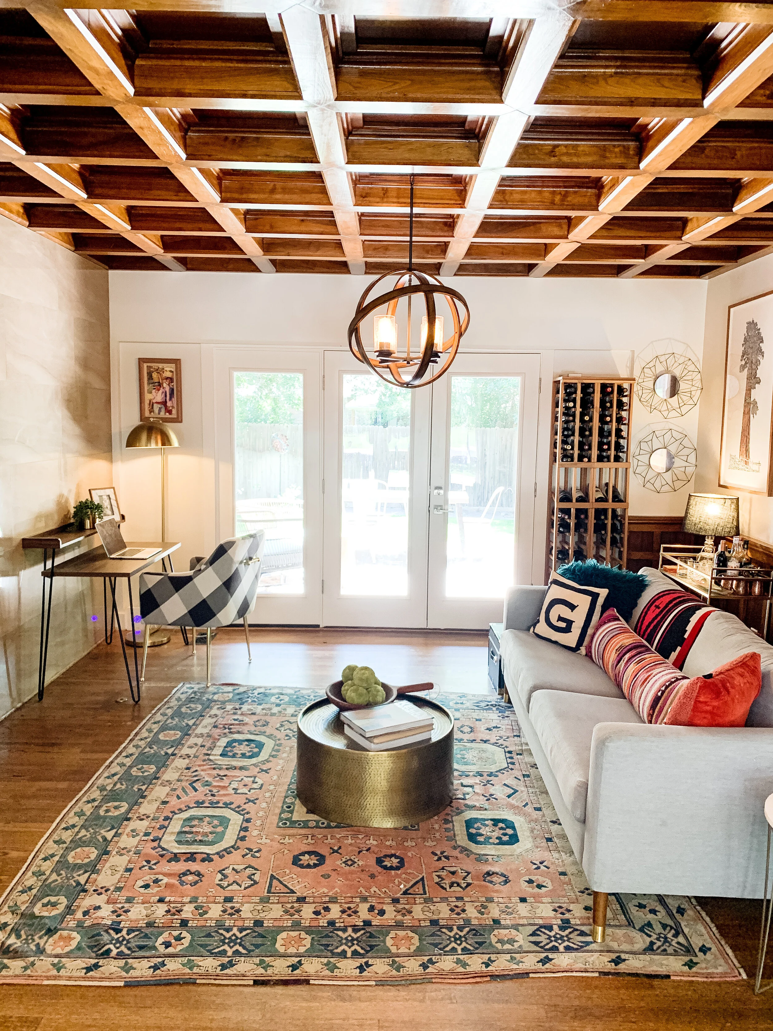   We intermixed Pendleton blankets and pillows and a pop of buffalo-check for the modern mountain house vibe as well. The brass bar cart and wine rack make this a wonderful and cozy entertaining space.”  