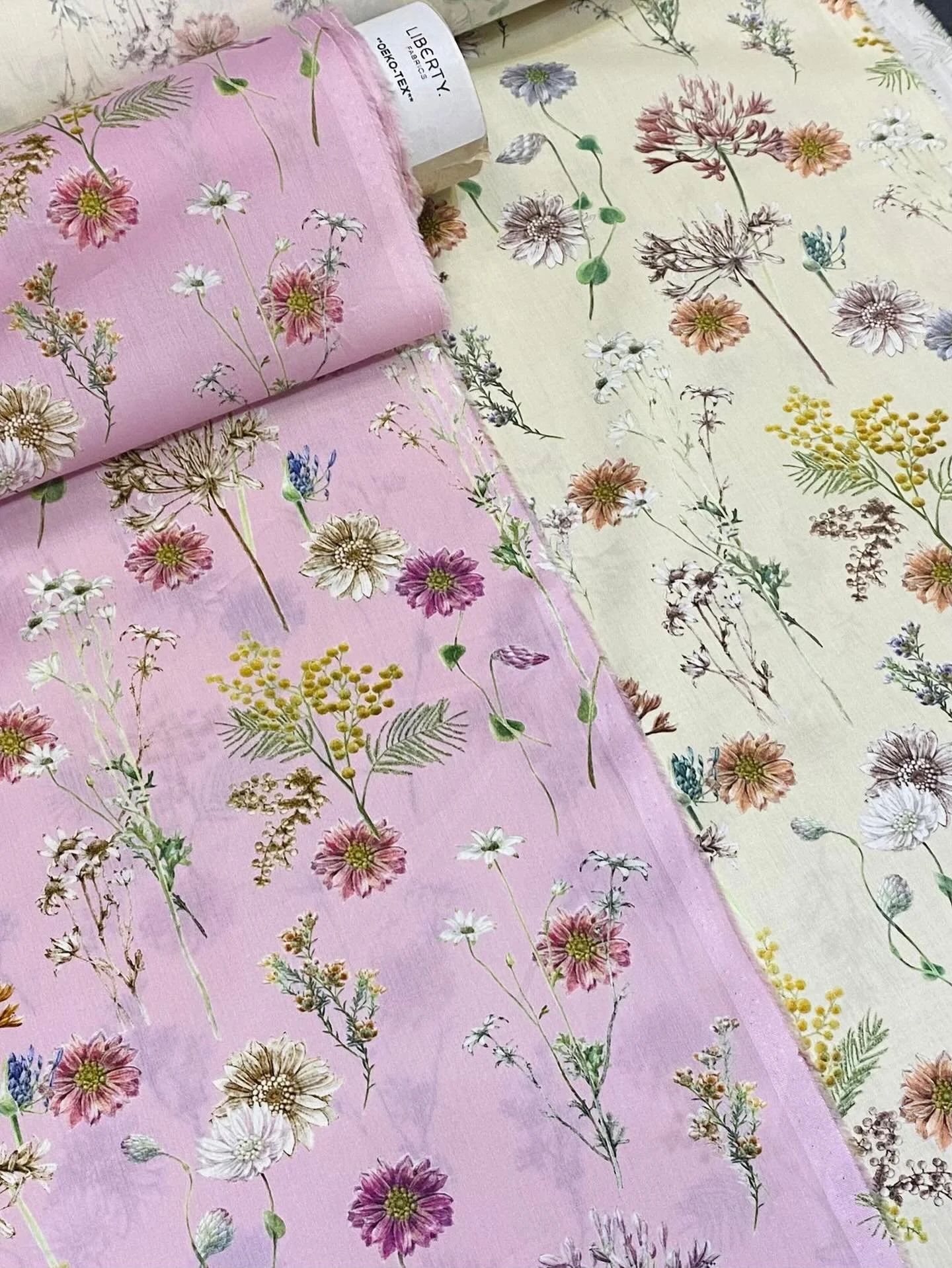 The duo - Polka Floral in soft petal pink and warm creamy beige. 
Hand-painted in watercolour with delicate pencil hatching, the print unfolds into a gentle landscape of blooms &mdash; agapanthus, mimosa, flannel flower, waxflower, and Australian str