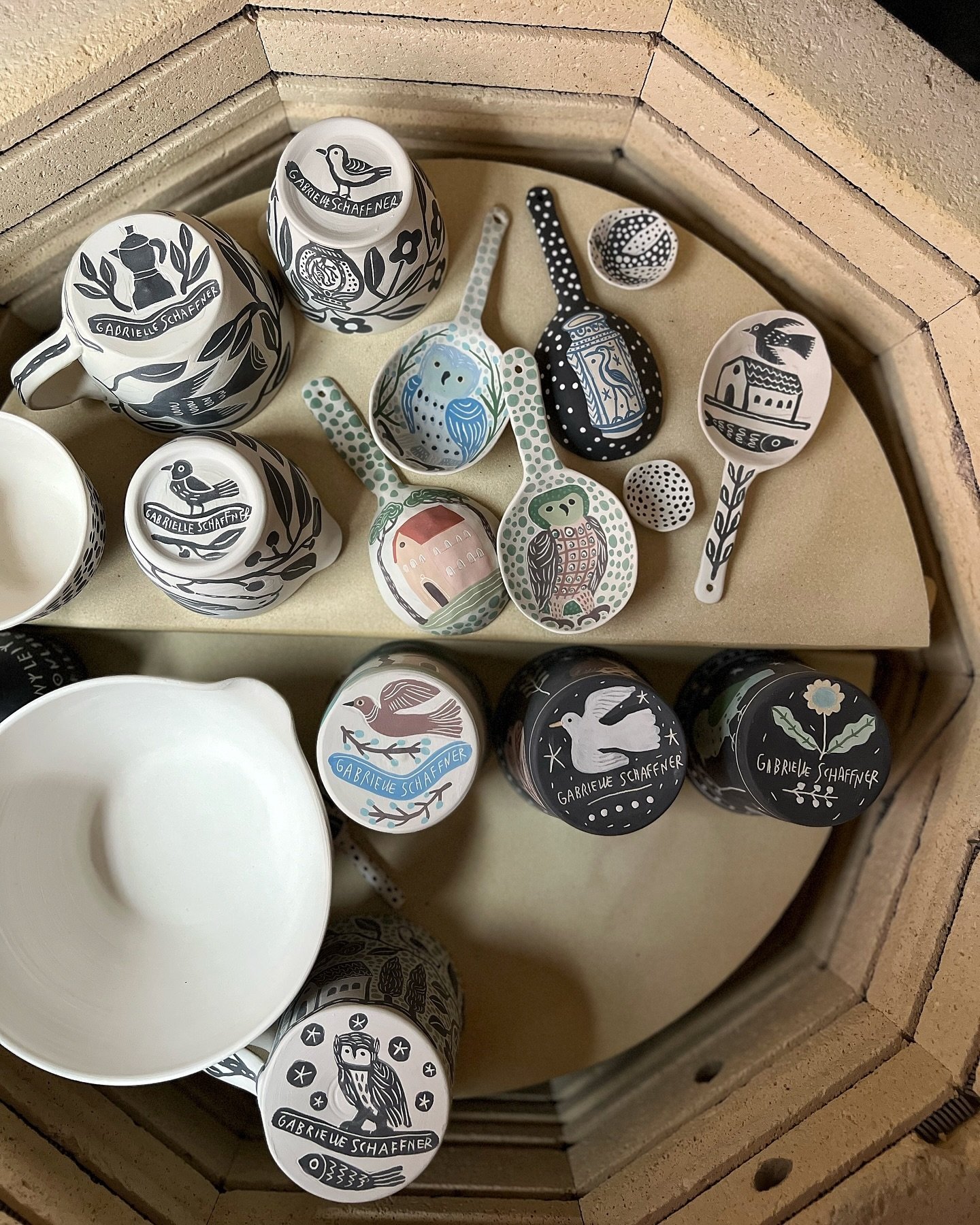 Nearly there for a full kiln. It&rsquo;s been so long I have no idea what on the lower shelves 😂

Second pic is the flip side of the large spoons, and the third is the cataclysmic mess of my current work table. The more I paint, the smaller my work 
