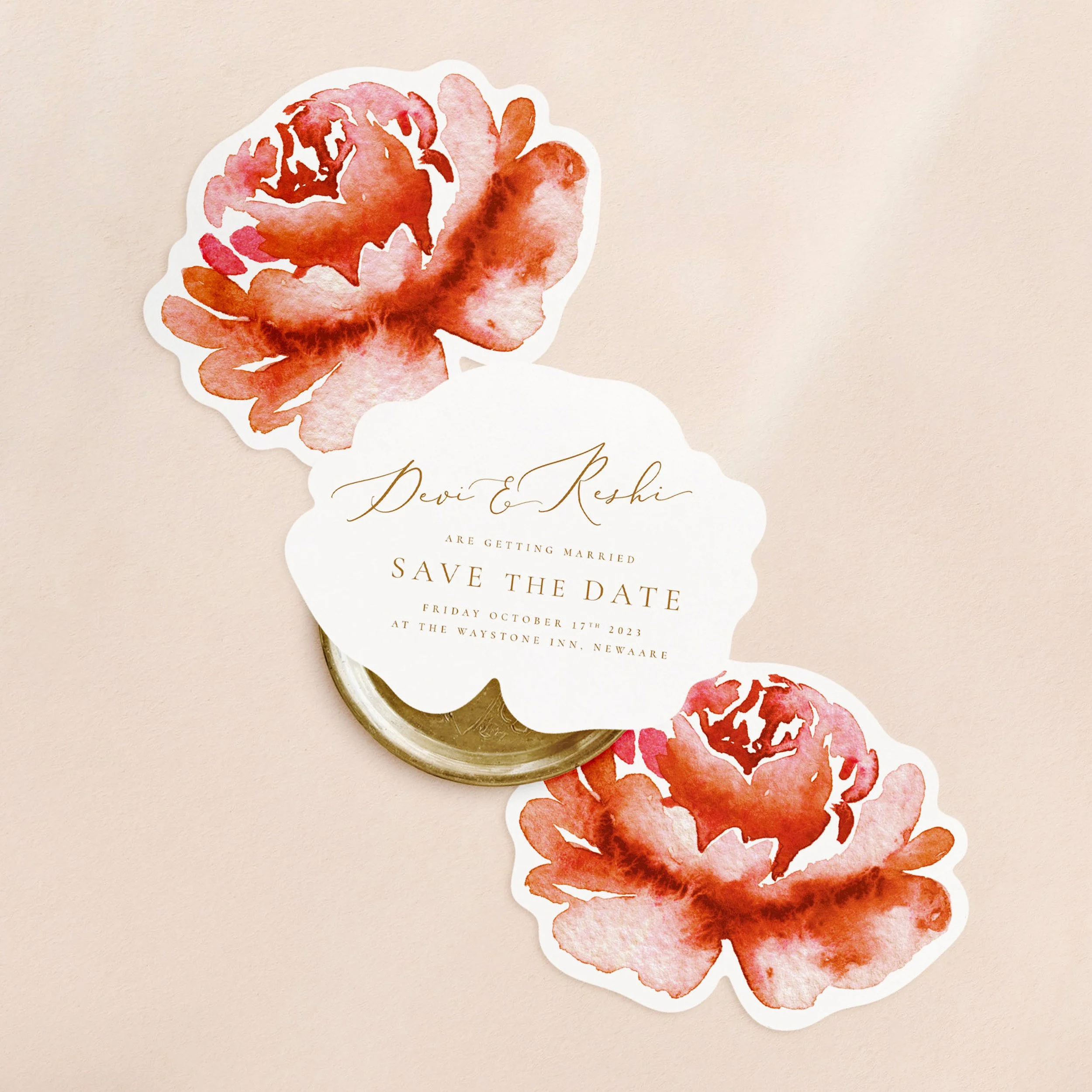Three flower shaped cards with a red watercolour flower on one side and wedding save the date wording in gold text on the other.