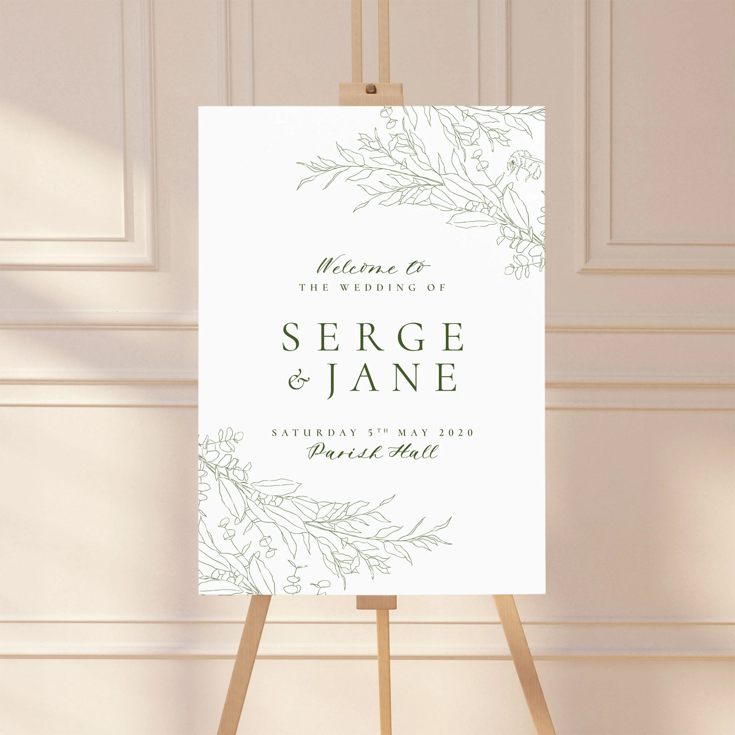 A large wedding welcome sign on an easel with a sketchy botanical leaf design.