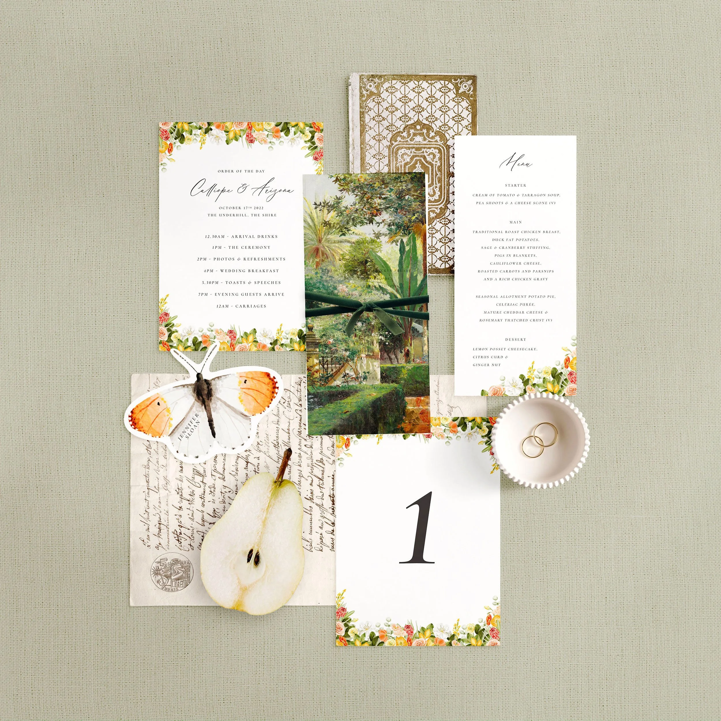 Wedding stationery flat lay featuring a menu, table number, order of the day and a butterfly shaped place card. Each has a yellow and orange citrus design.