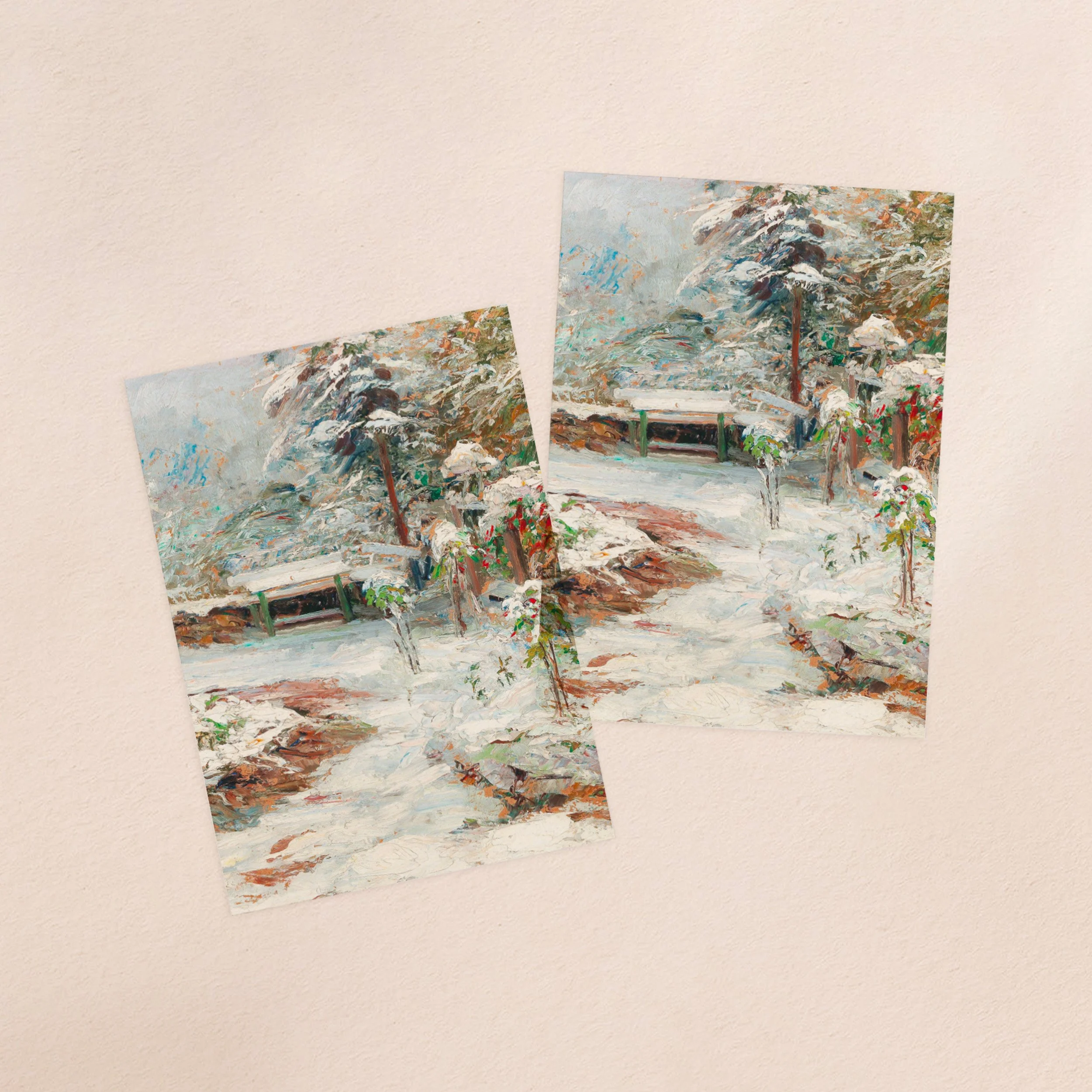 Two vellum paper overlay sheets printed with a snow scene including a bench and trees covered in snow.