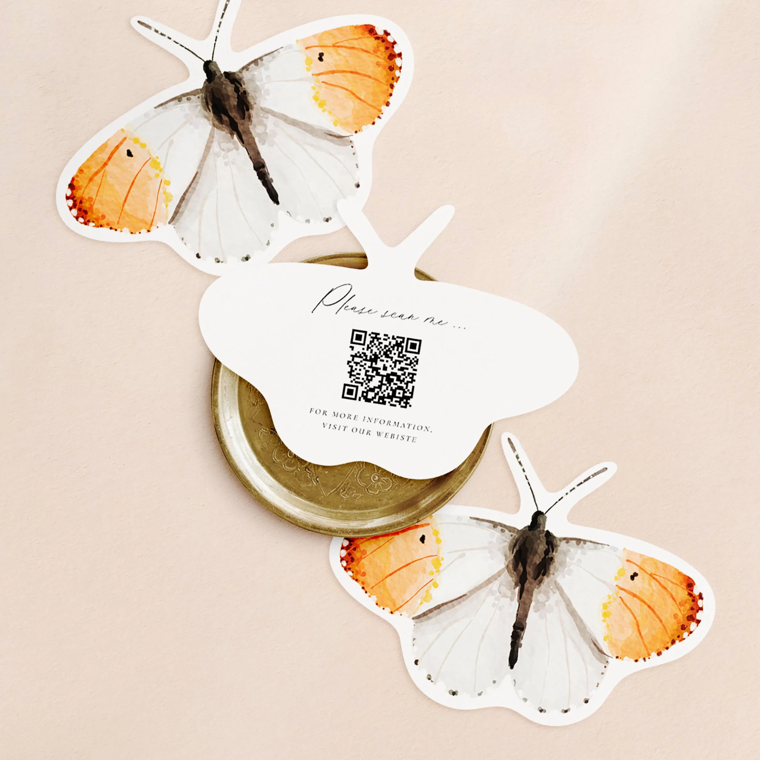 Three butterfly-shaped cards with an orange-tip butterfly watercolour painting on one side and a qr code printed on the other.