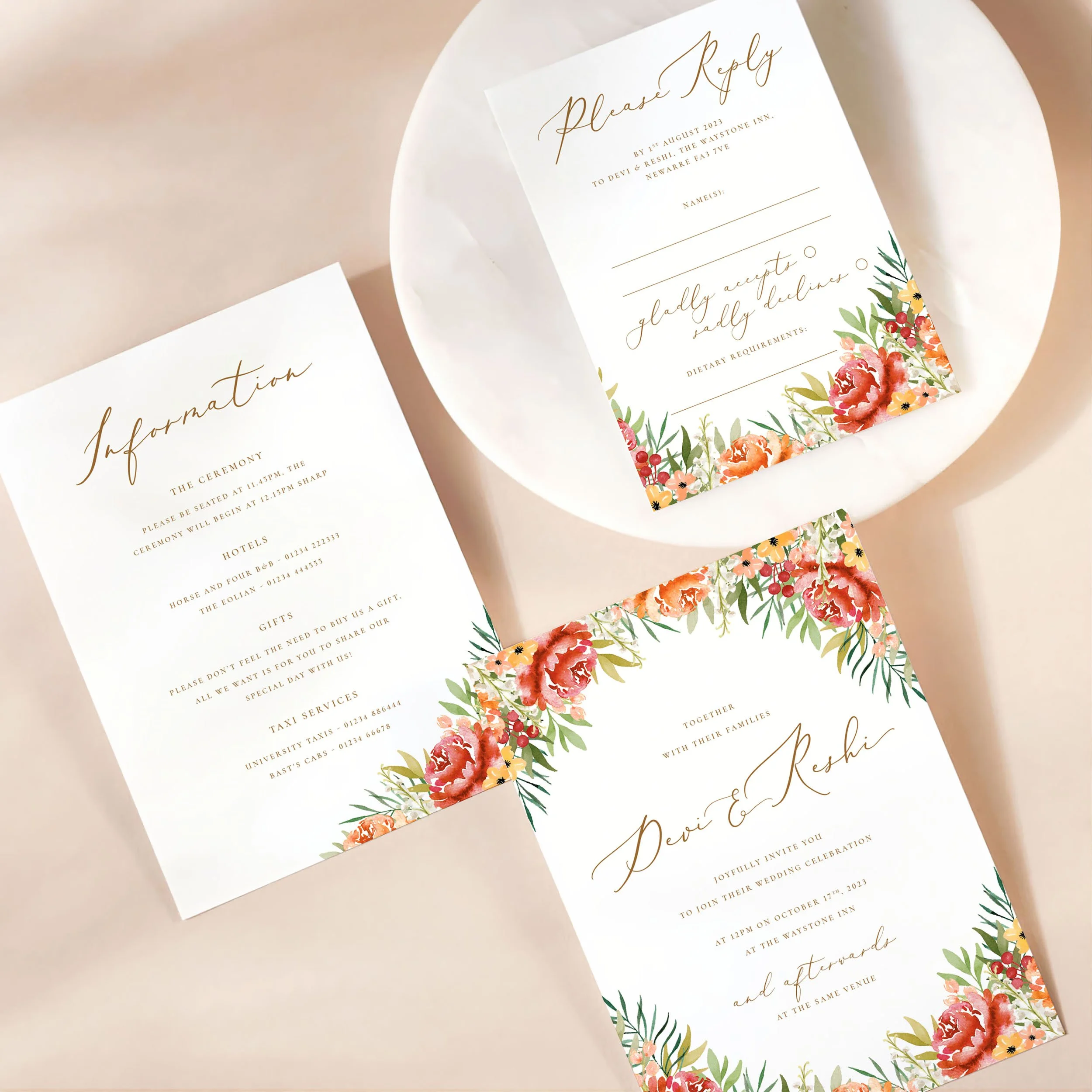 A wedding invitation card with details card and rsvp on a marble dish. There is an autumnal burgundy and orange floral design on each card.
