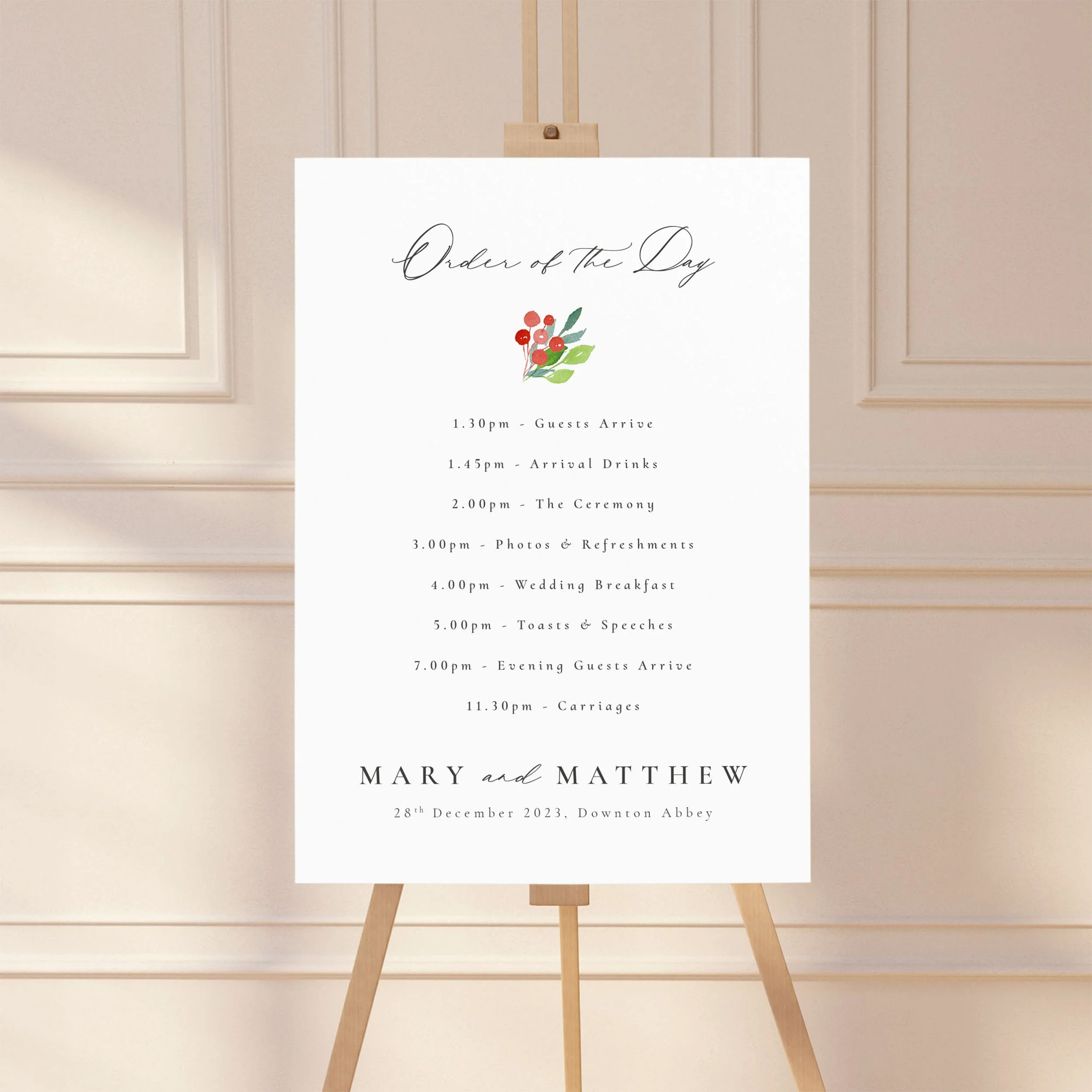 Large sign on an easel displaying a wedding order of the day timeline, featuring a wintery motif design
