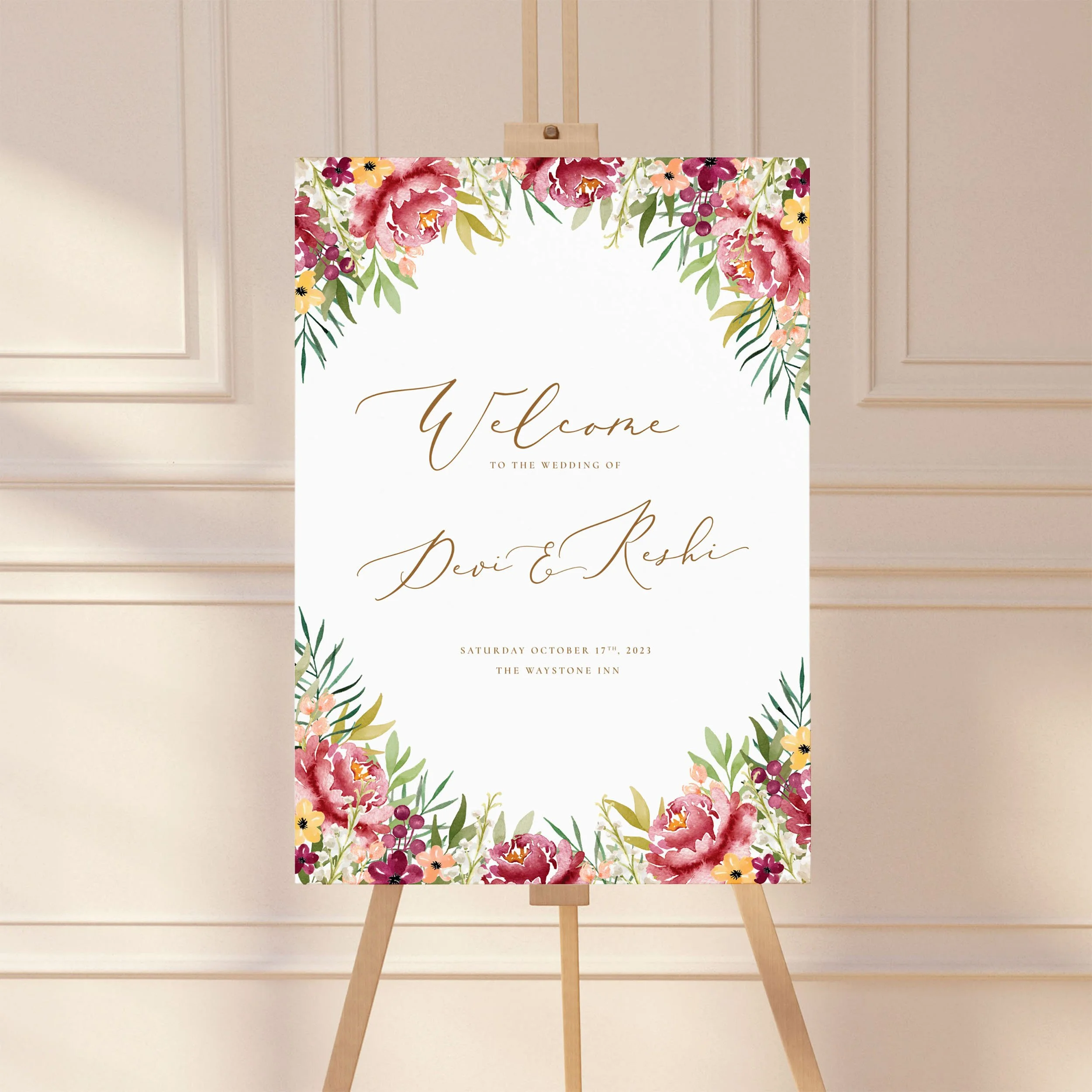 A large wedding welcome sign on an easel with a burgundy watercolour flower design.