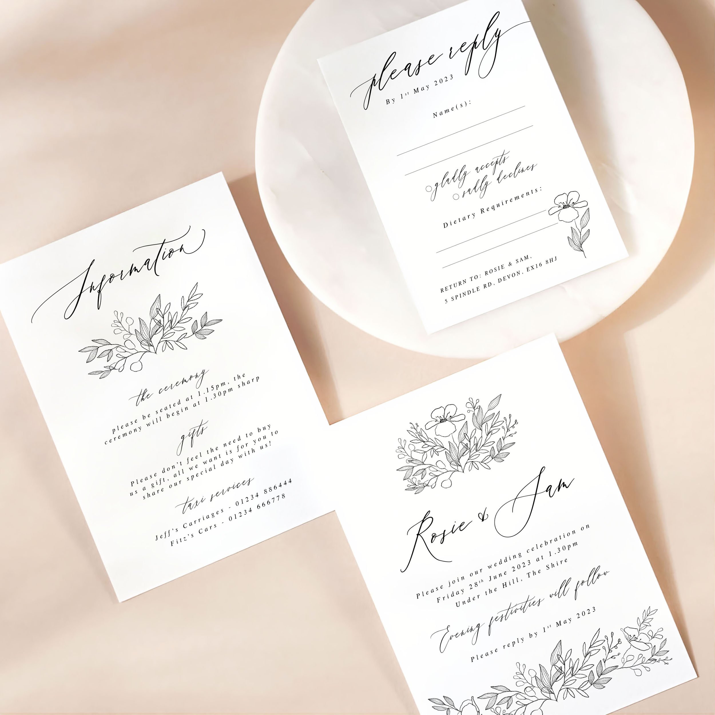 A wedding invitation card with details card and rsvp on a marble dish. There is a modern black flower sketch design on each card.