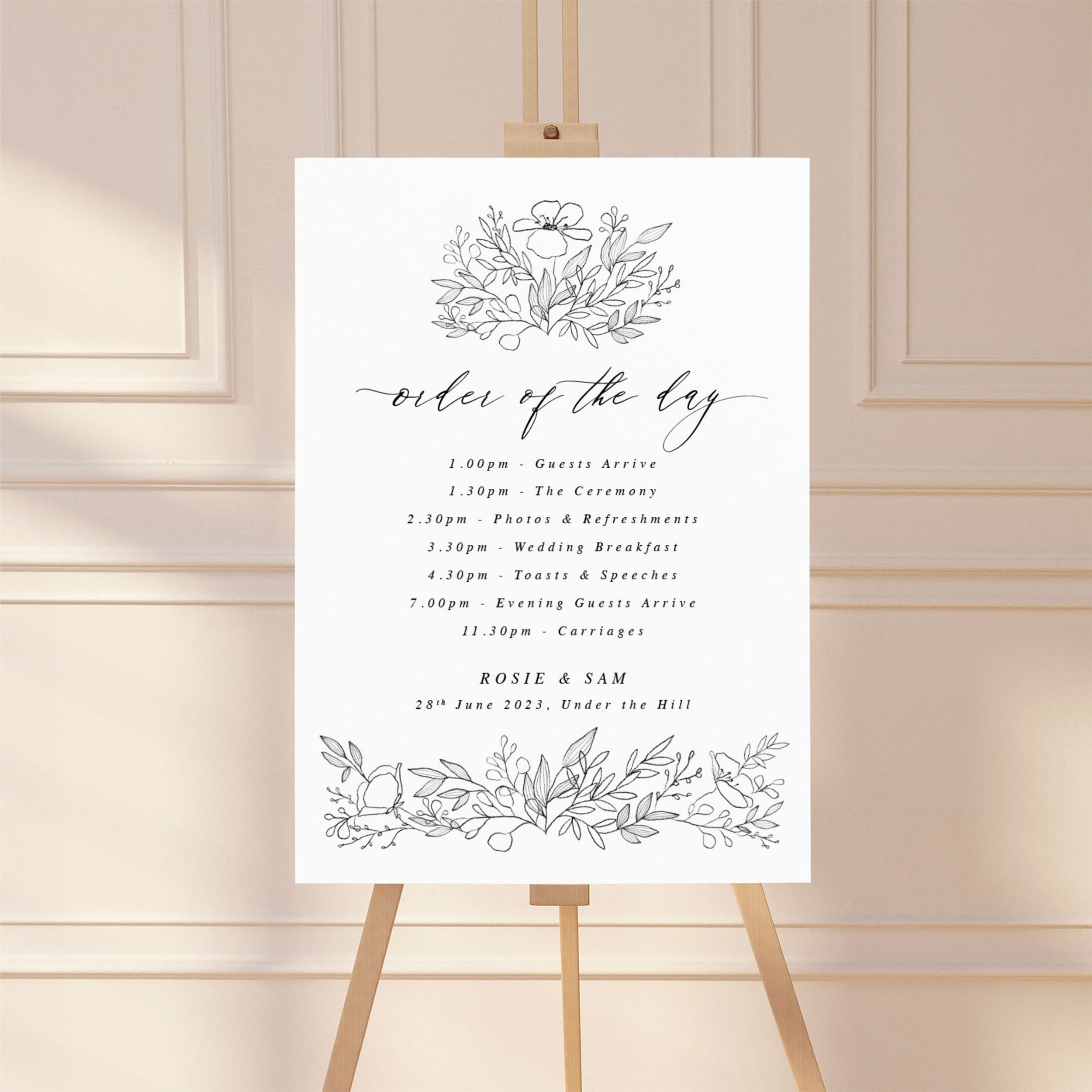 Large sign on an easel displaying a wedding order of the day timeline, featuring a black sketch motif design