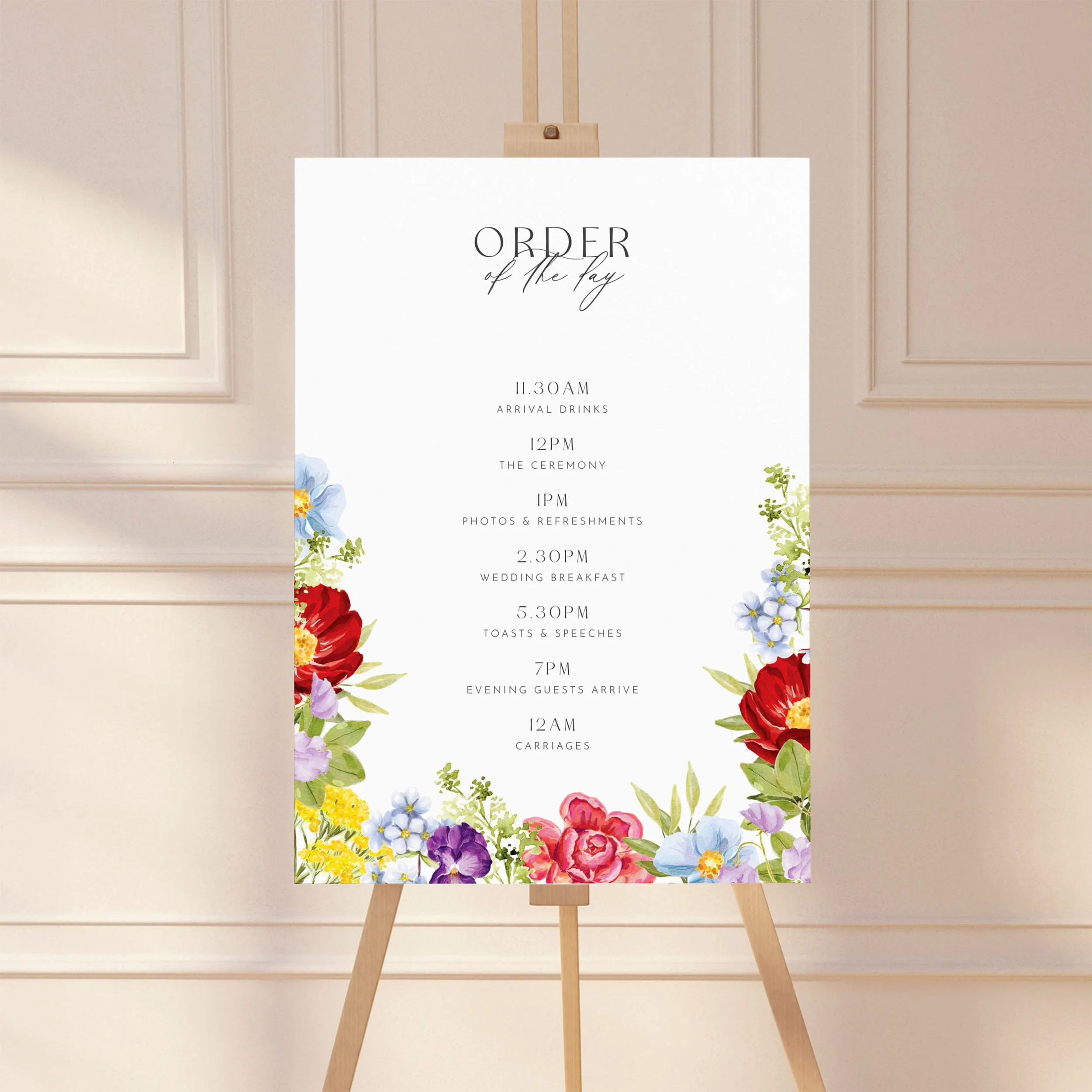Large sign on an easel displaying a wedding order of the day timeline, featuring a bright floral design