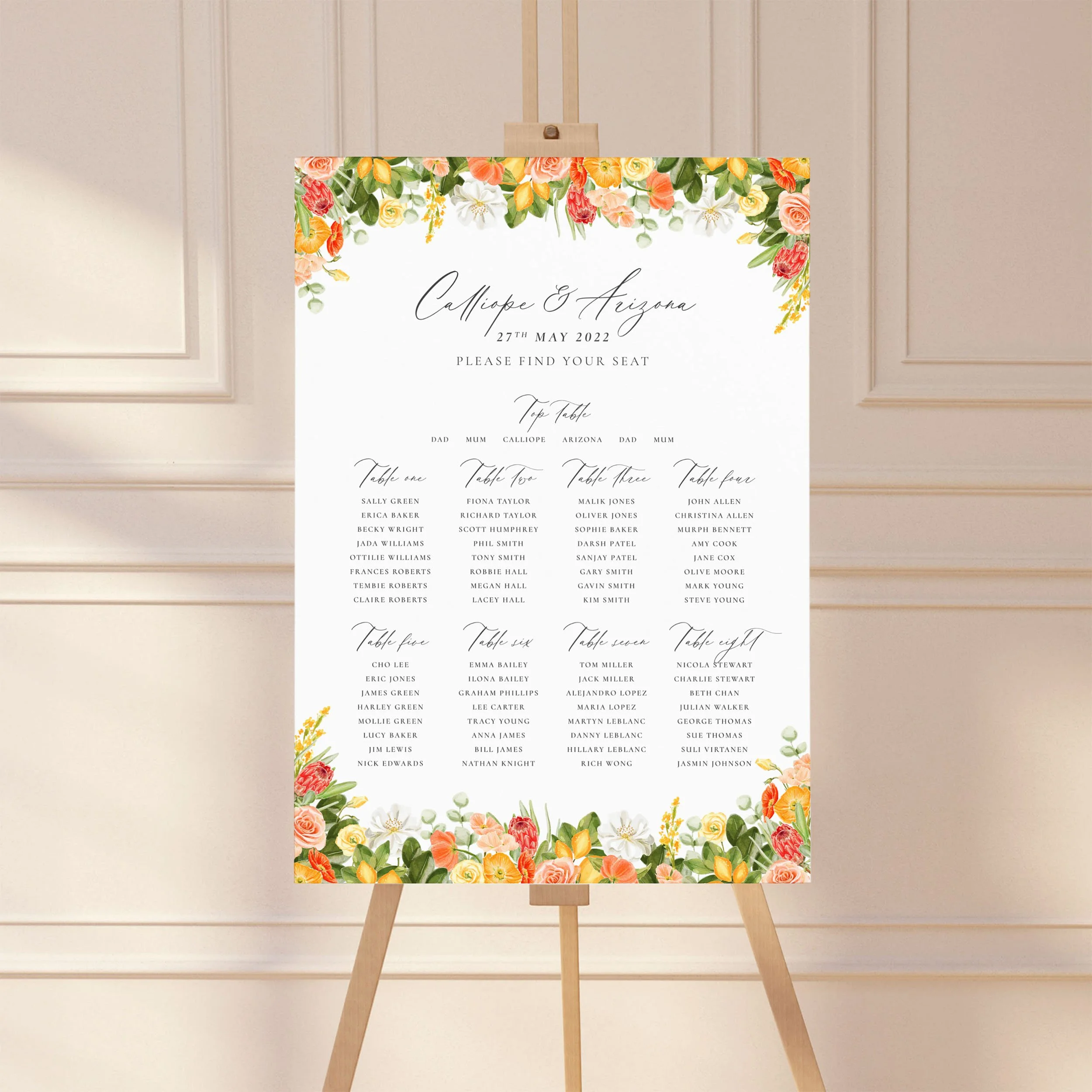 A wedding table plan sign printed on a large A1 board, standing on an easel. The design has bright watercolour floral elements framing the top and bottom.