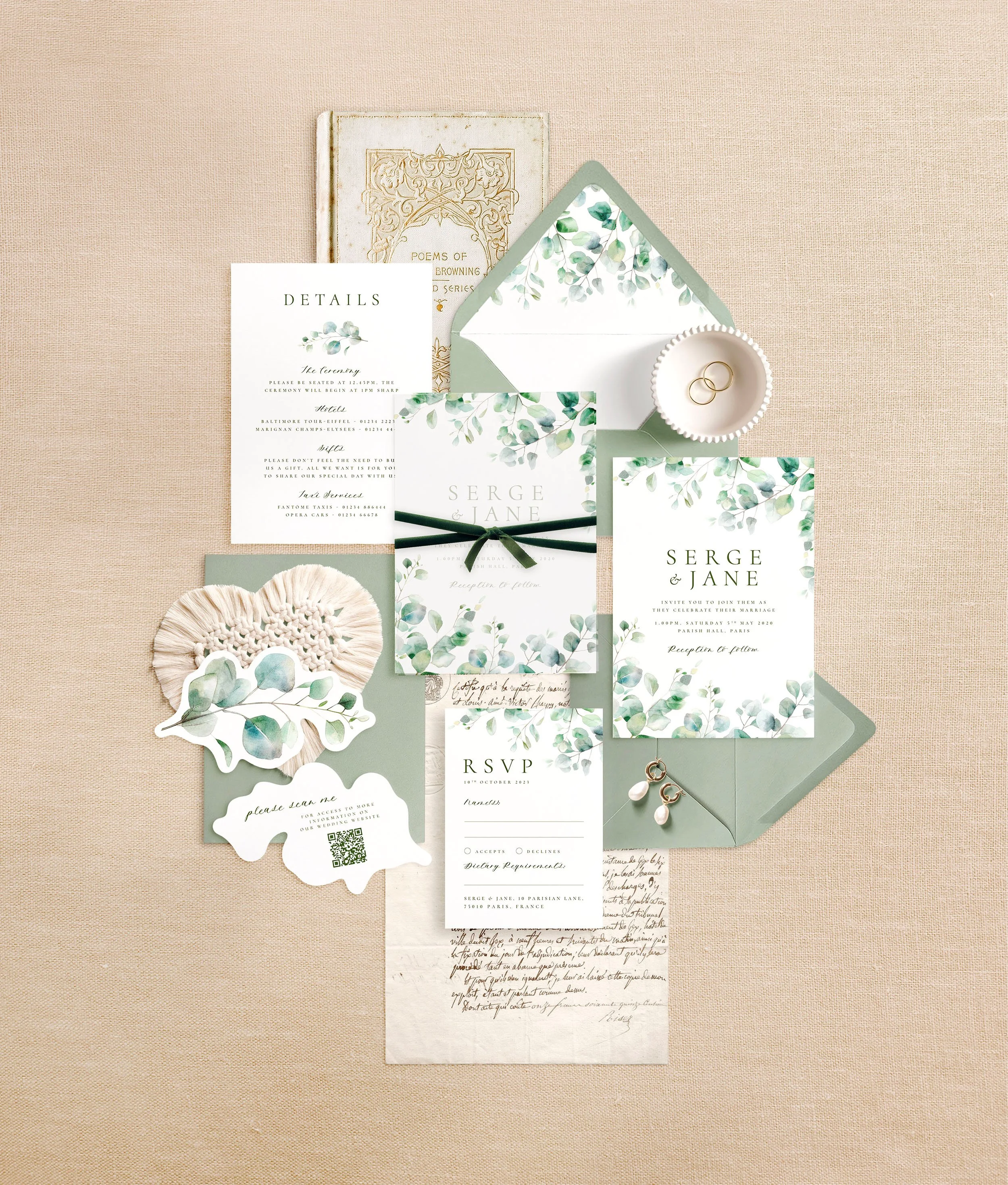 Wedding stationery flat lay featuring invitations, details, rsvp and a eucalyptus shaped qr code card. A sage green watercolour eucalyptus design.