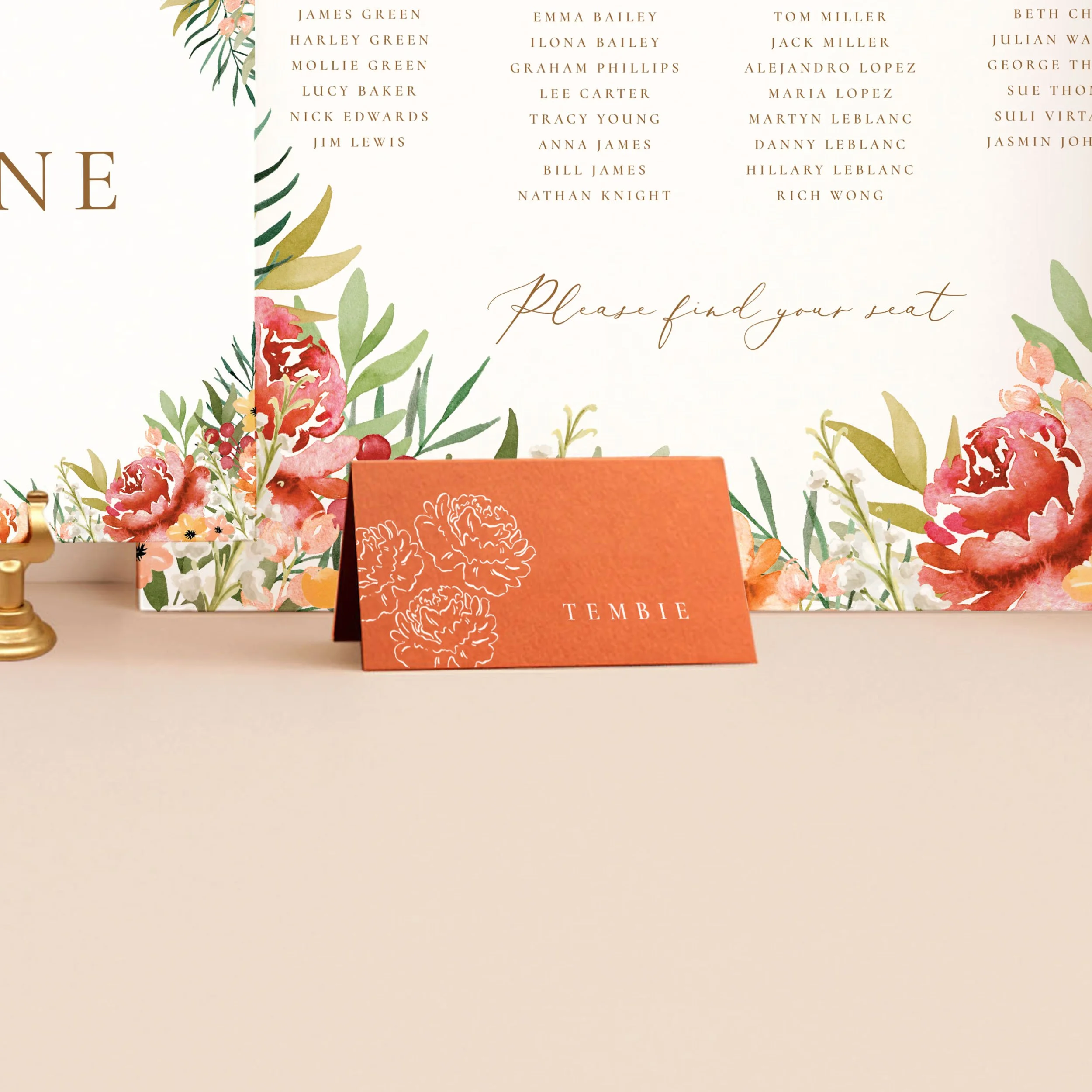An orange tent place card, printed in white ink with a guest name and an illustration or 3 peony flowers.