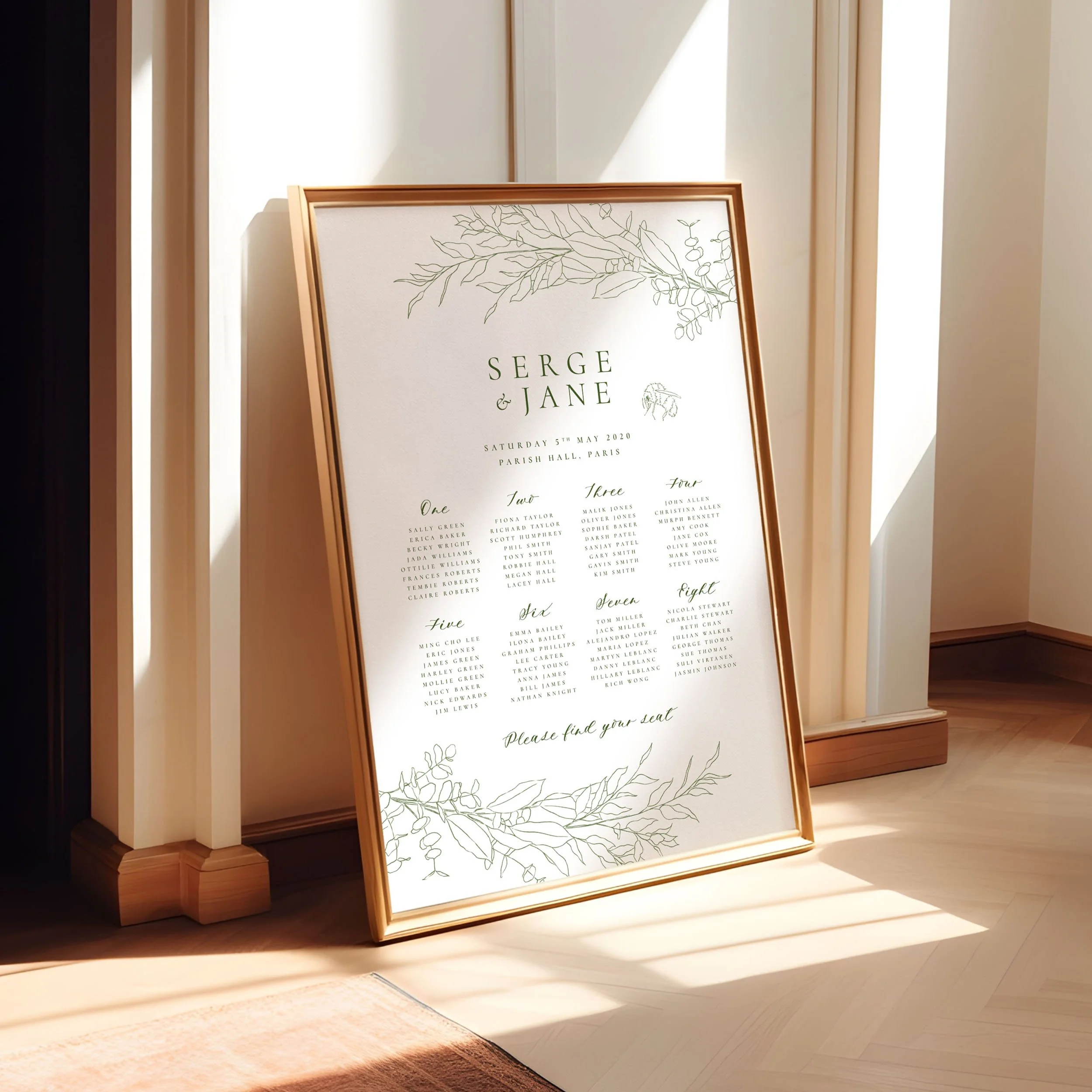 A framed A1 table plan sign leaning against a wall as the light spills across. The design has a delicate hand drawn bumble bee and leaves in green..