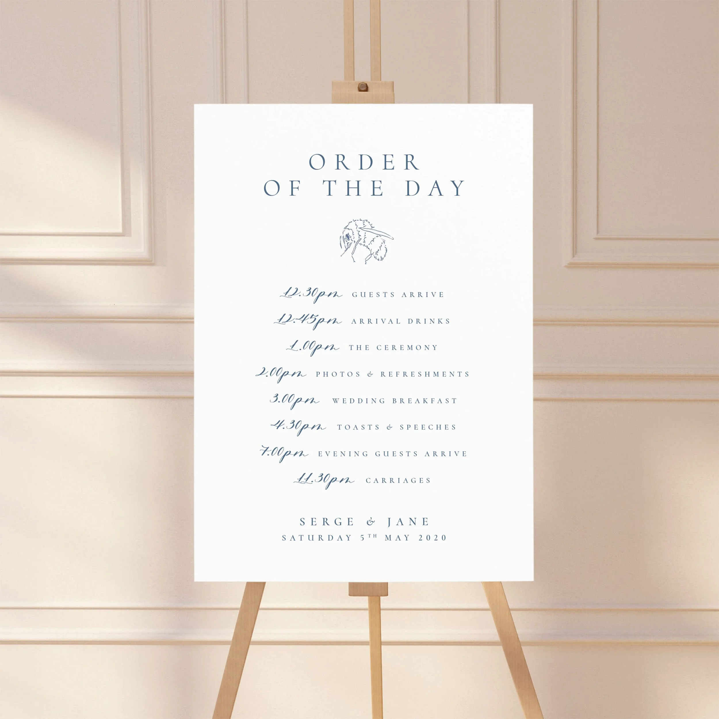 Large sign on an easel displaying a wedding order of the day timeline, featuring a dusty blue design with a bumble bee