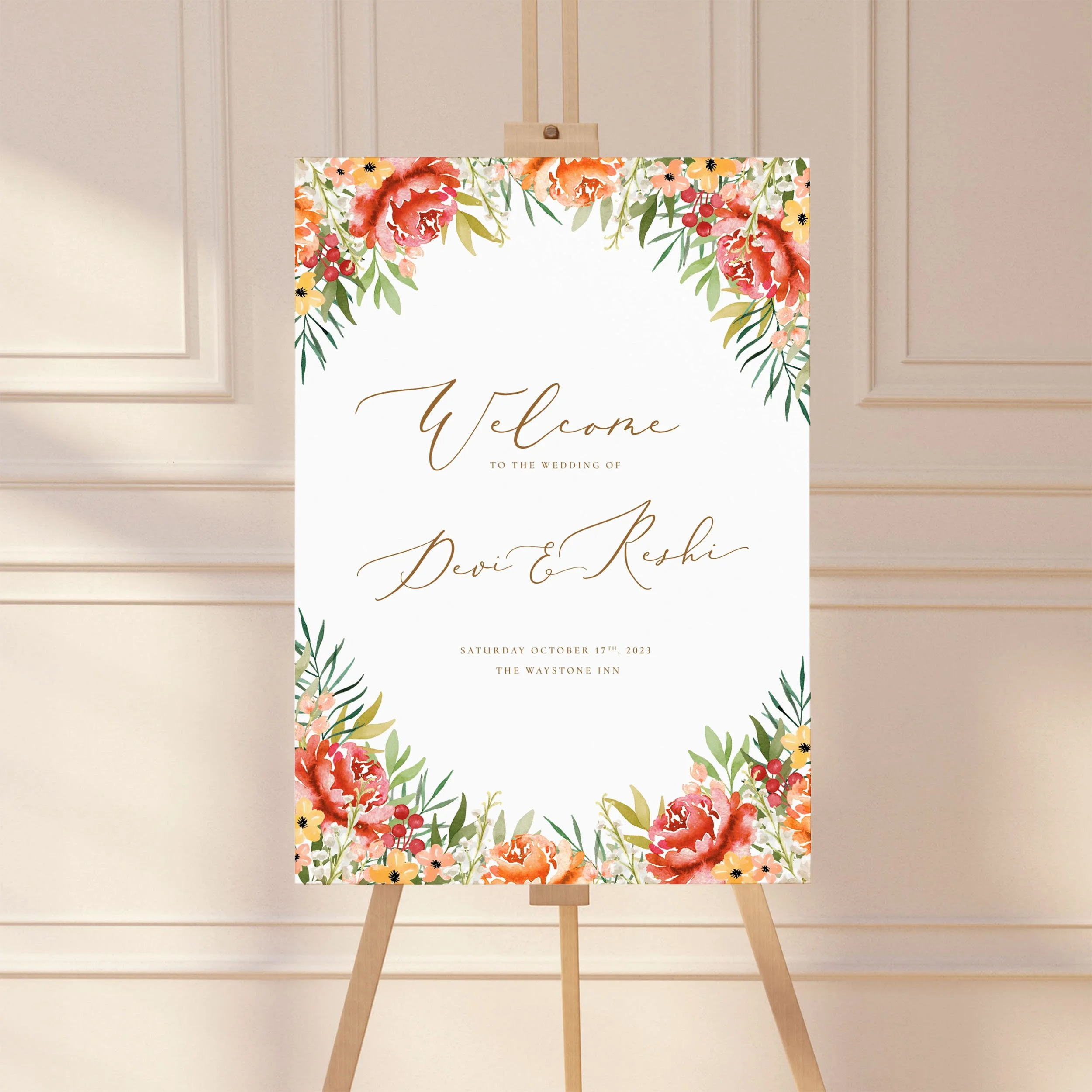 A large wedding welcome sign on an easel with a watercolour burnt orange flower design.