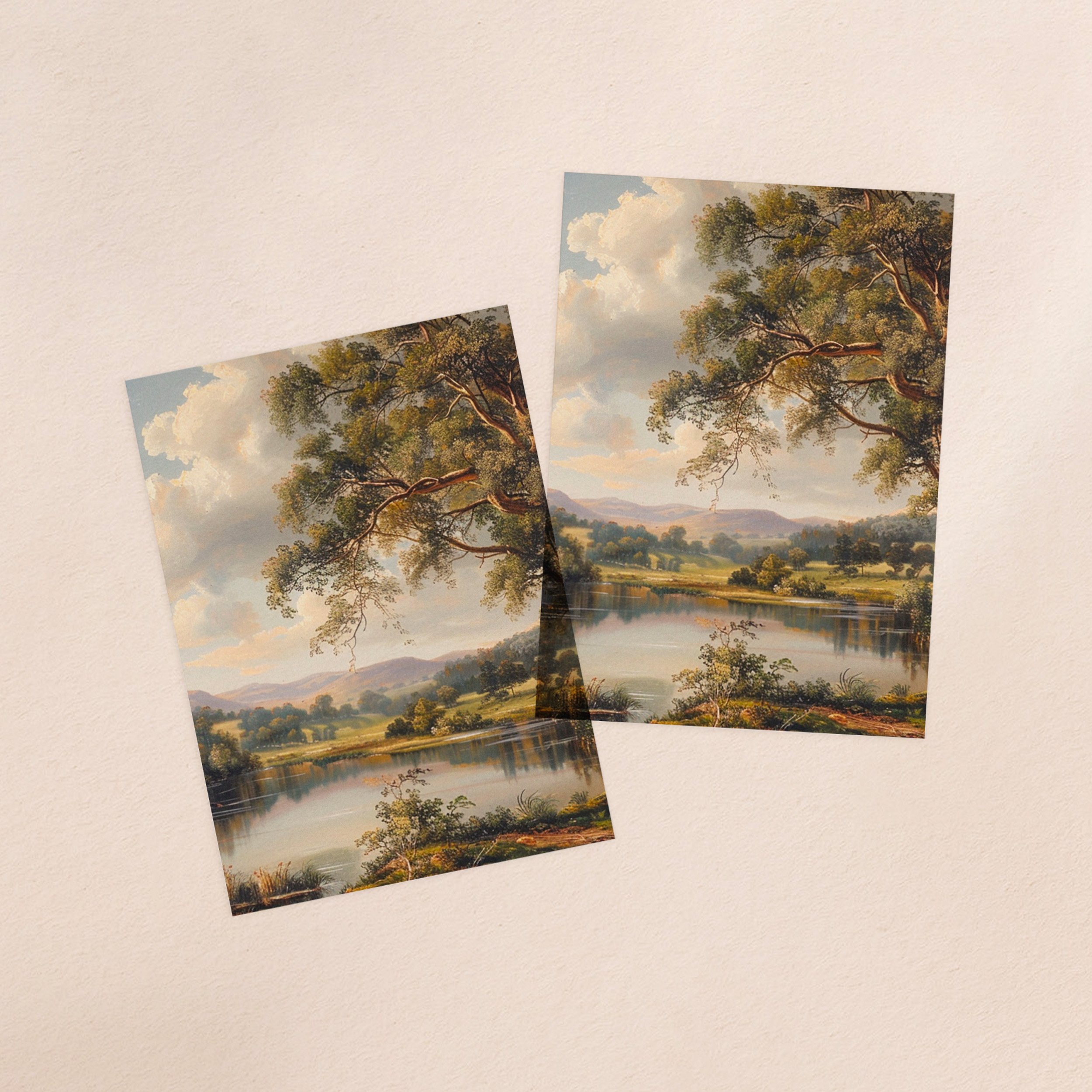 Two vellum paper overlay sheets printed with a lush green landscape with a lake in the foreground