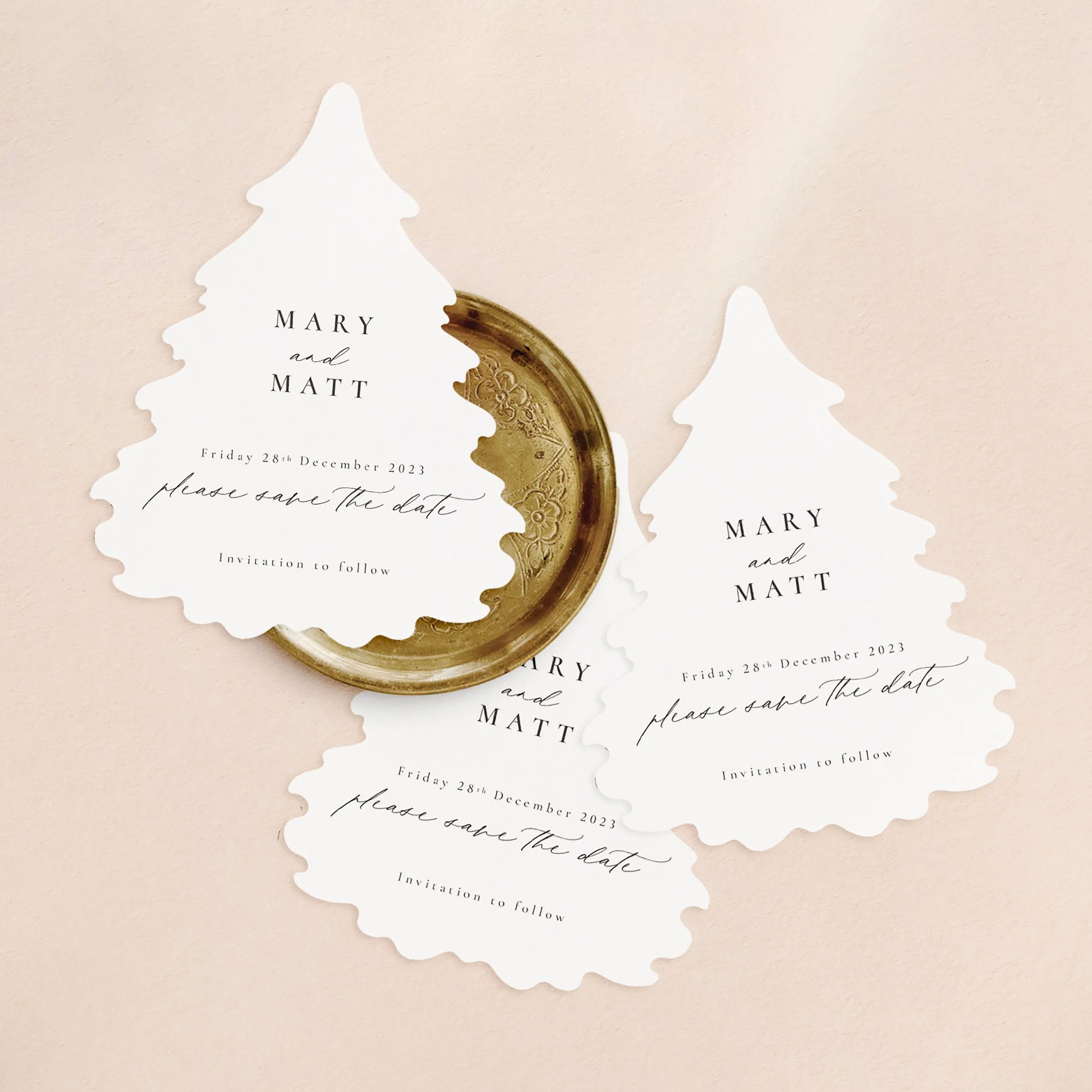 Three Christmas tree shaped cards with wedding save the date wording.