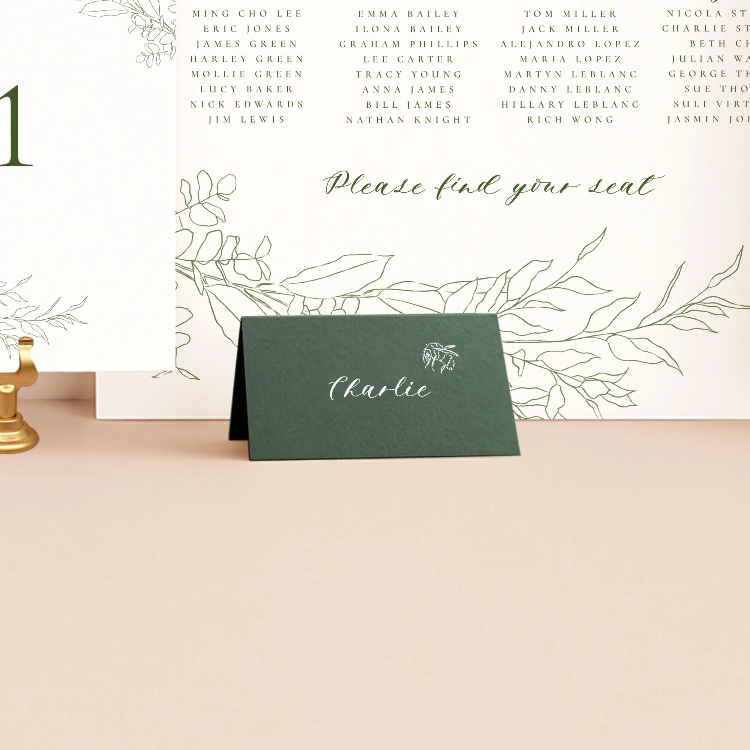 A rich green tent place card, printed in white ink with a guest name and a small bee illustration.