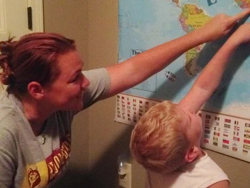 At their Clarksville home, Jamie and Darren Baysore place stickers on a map showing the locations where people sent photos of their porchlights from Friday night. (Photo: THE LEAF-CHRONICLE/PHILIP GREY)