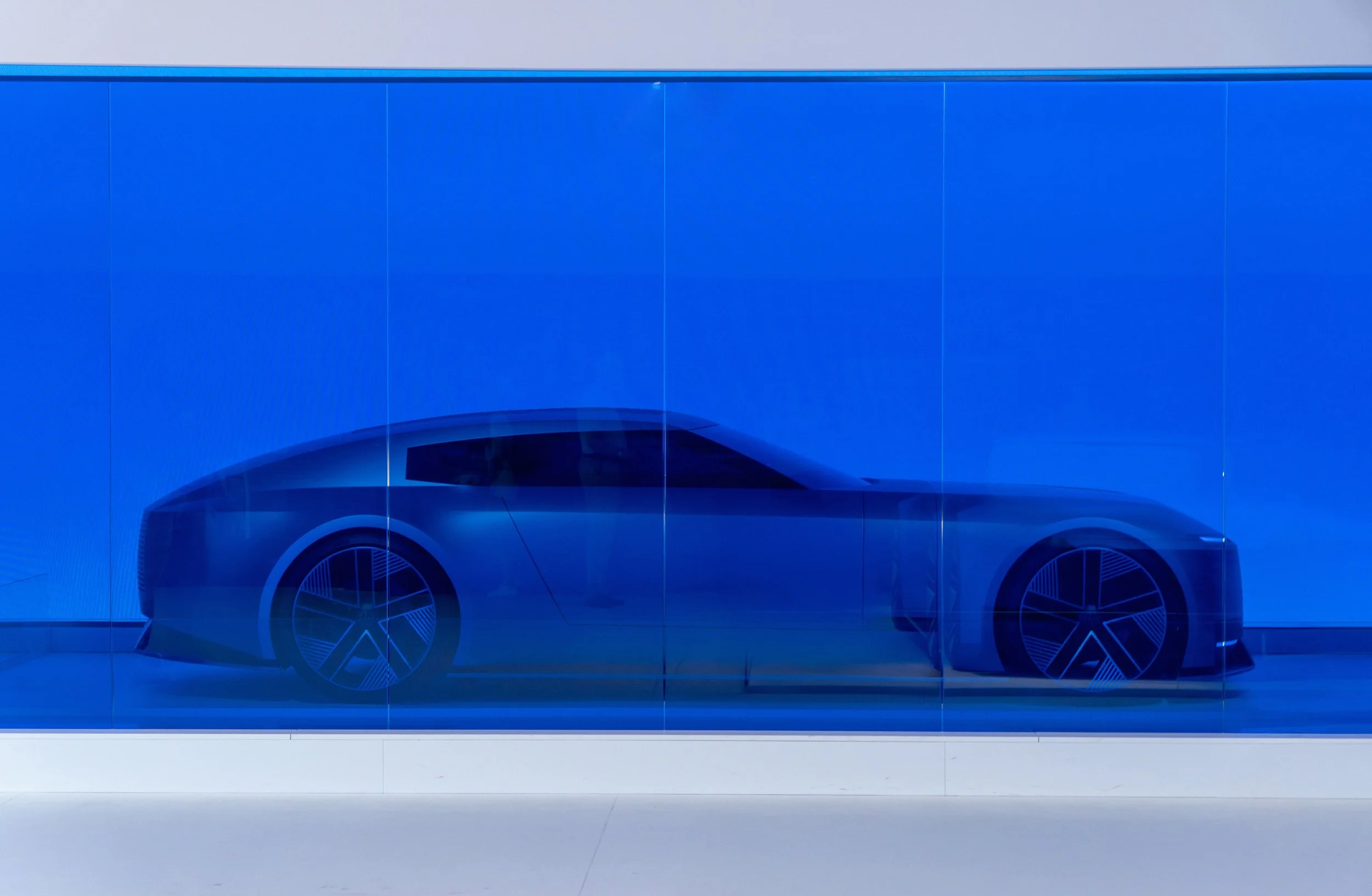 https://unsplash.com/photos/a-futuristic-car-is-displayed-in-a-blue-case-F-4ulSI63_c