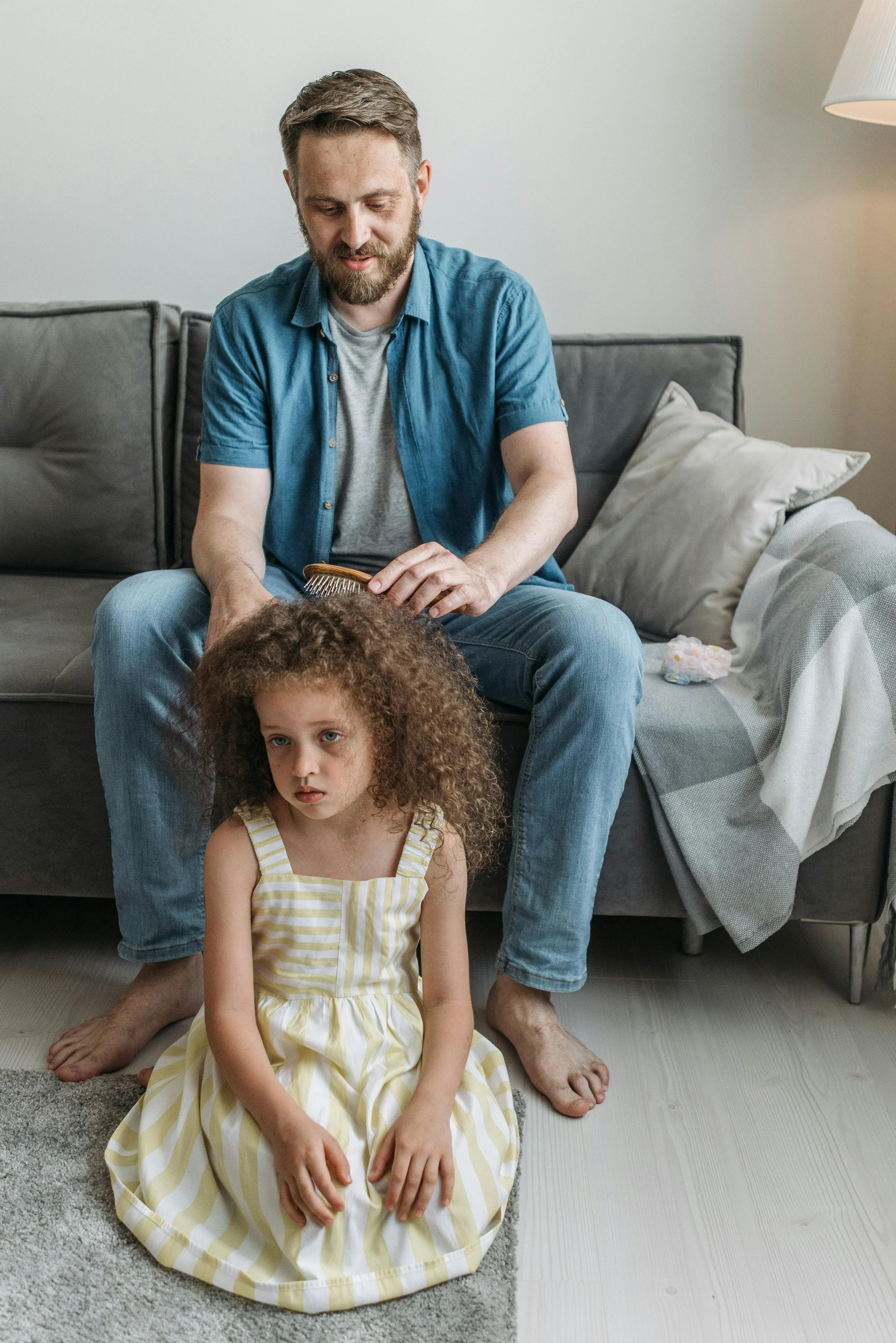 Man Brushing his Daughter's Hair
