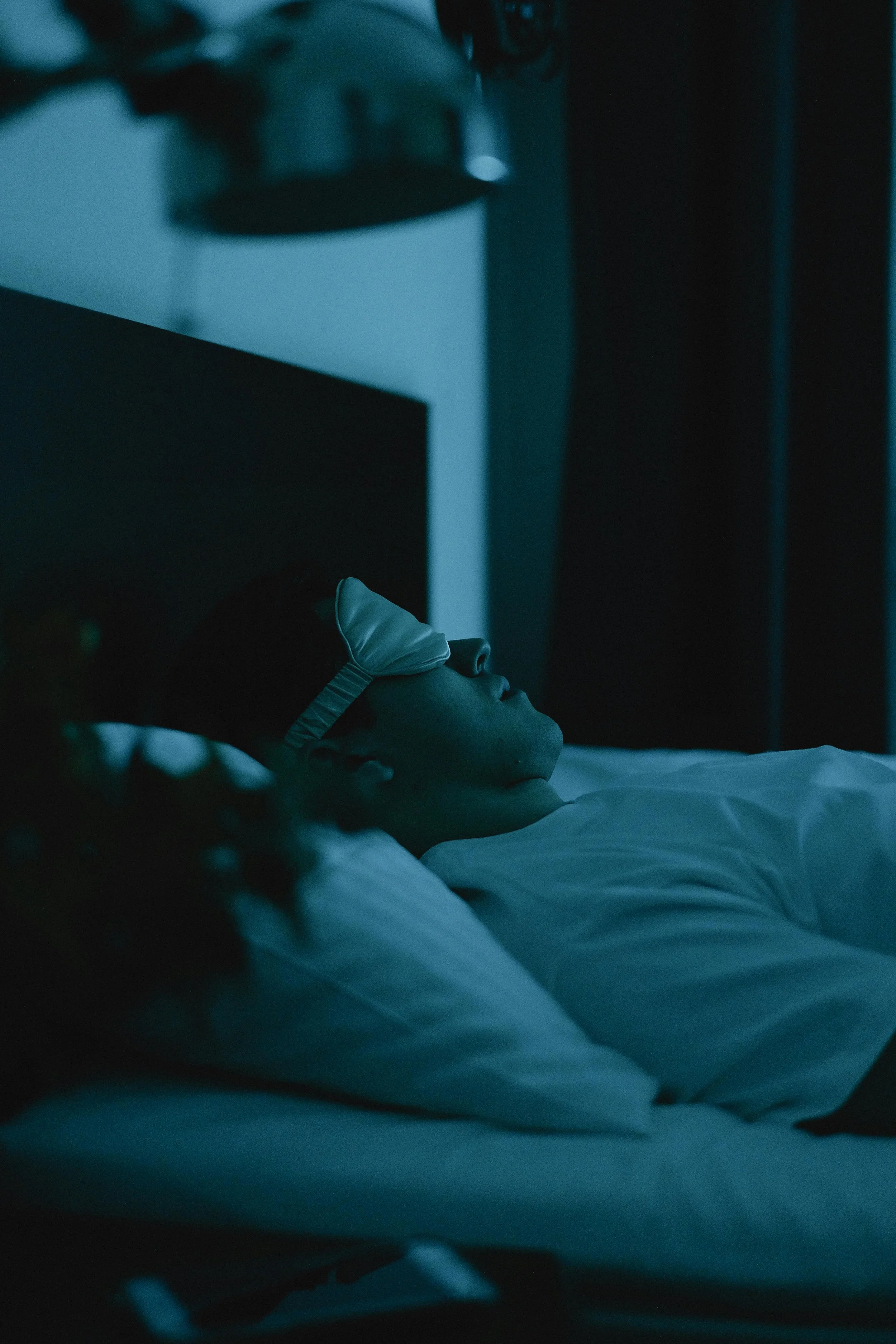 Man Wearing a Sleep Mask Lying on Bed
