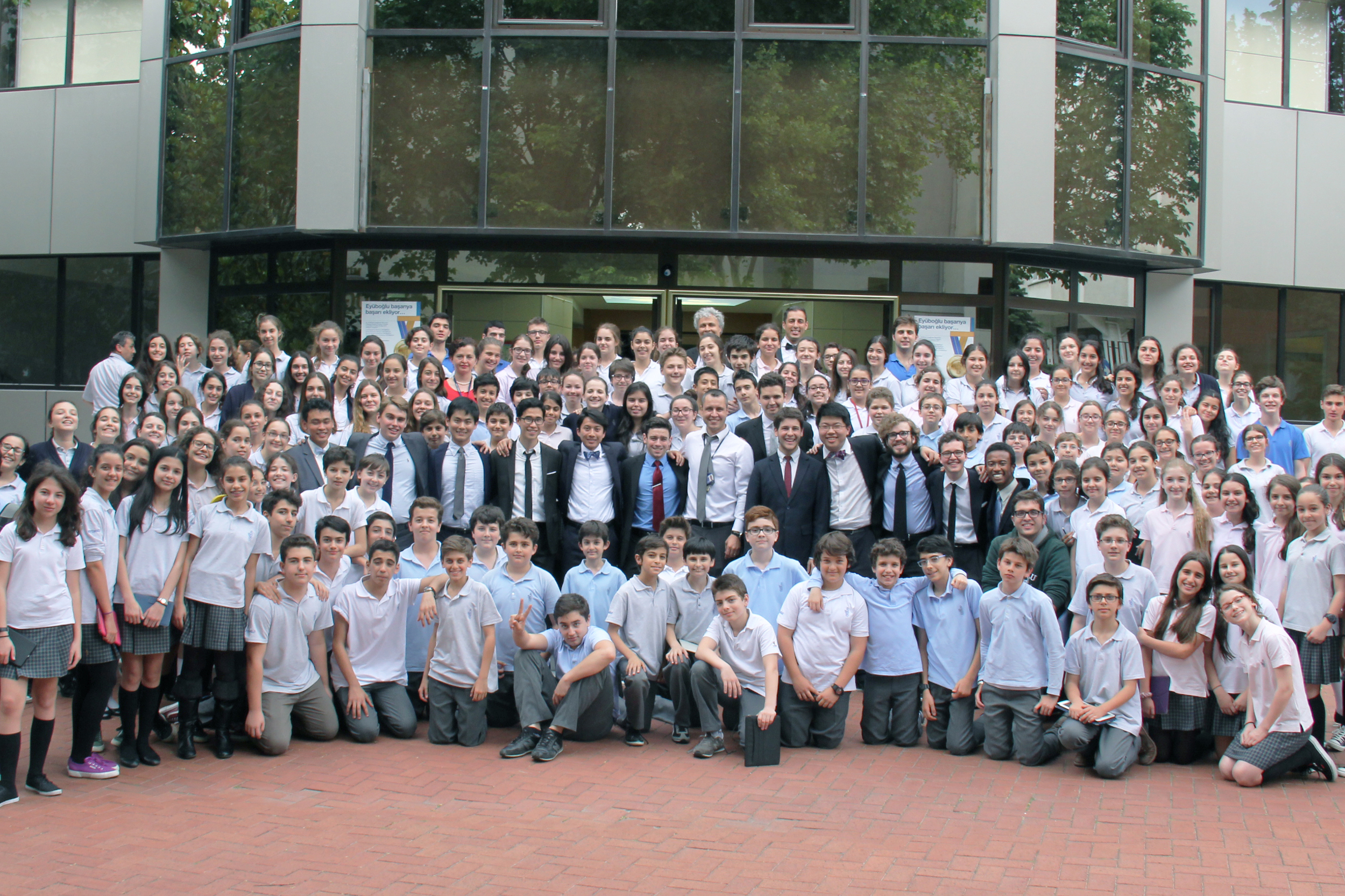 The Cats take a group shot with Eyuboglu High School in Istanbul, Turkey